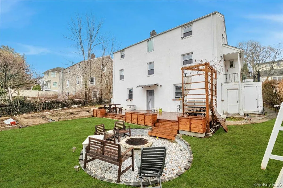 Fenced-in Backyard w/ Planting Boxes and Fire Pit Area Fenced-in Backyard w/ Planting Boxes and Fire Pit Area