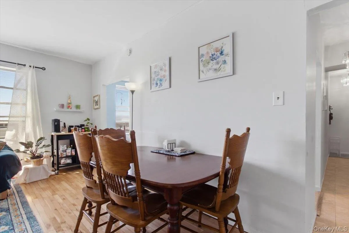 Dining area with light wood-style flooring Dining area with light wood-style flooring