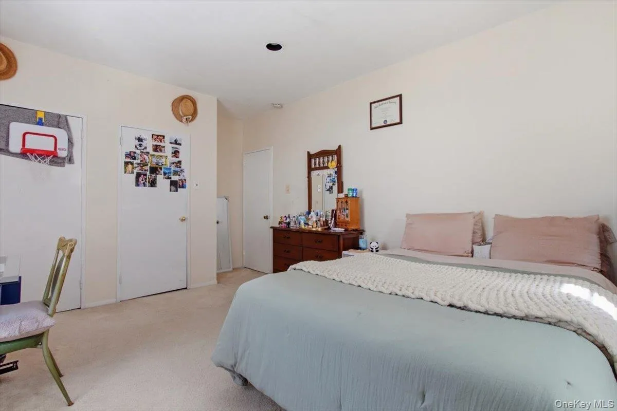 Bedroom featuring light colored carpet Bedroom featuring light colored carpet