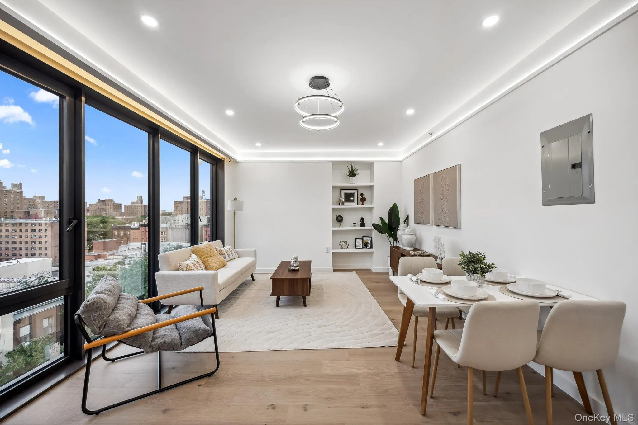 Dining space with electric panel, wood finished floors, a view of skyline, and recessed lighting Dining space with electric panel, wood finished floors, a view of skyline, and recessed lighting