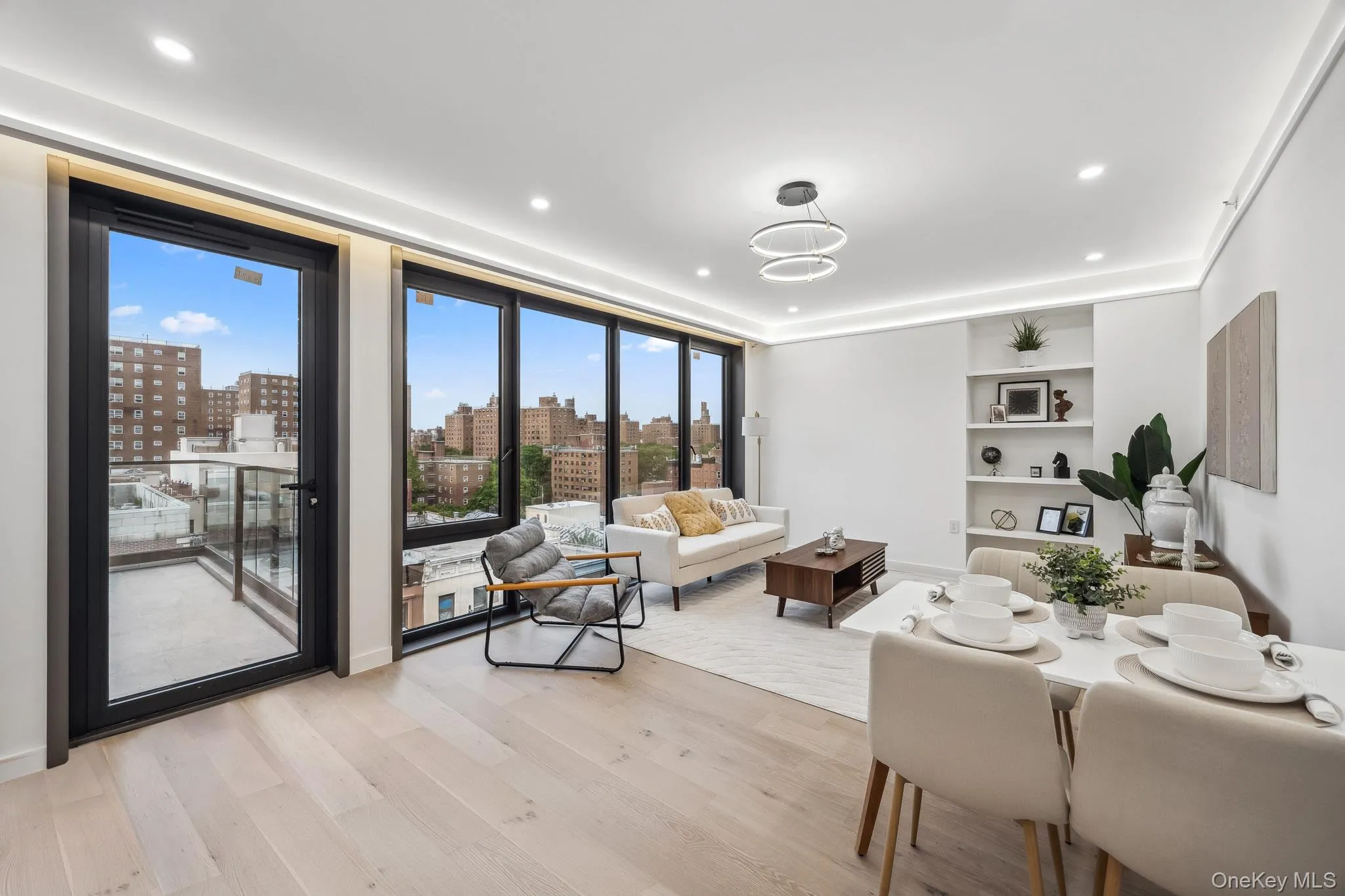 Living room featuring light wood finished floors, a view of city, and recessed lighting Living room featuring light wood finished floors, a view of city, and recessed lighting