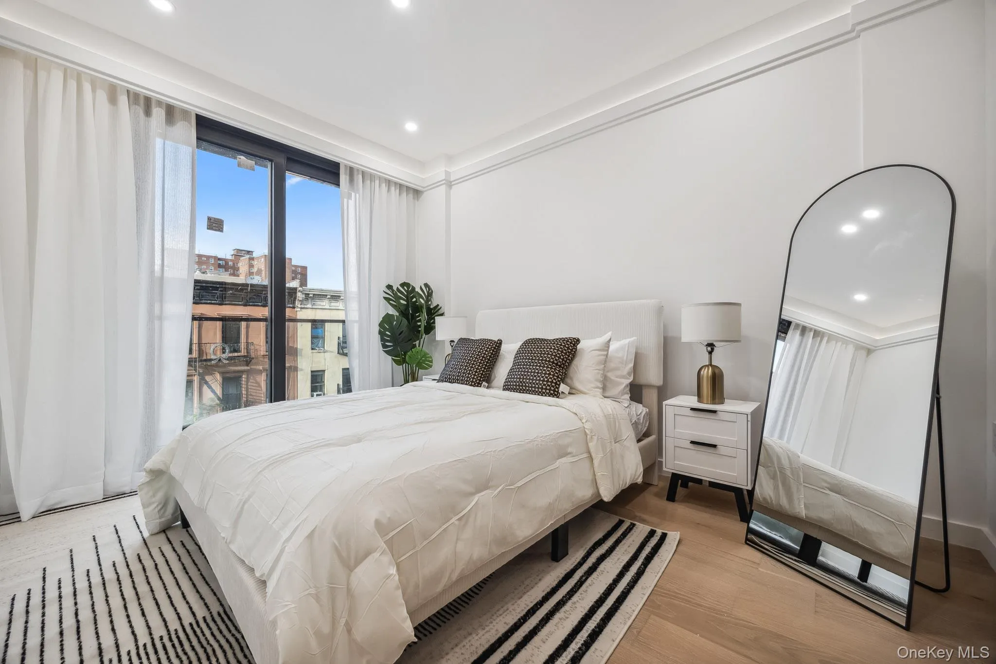 Bedroom with light wood-style flooring and recessed lighting Bedroom with light wood-style flooring and recessed lighting