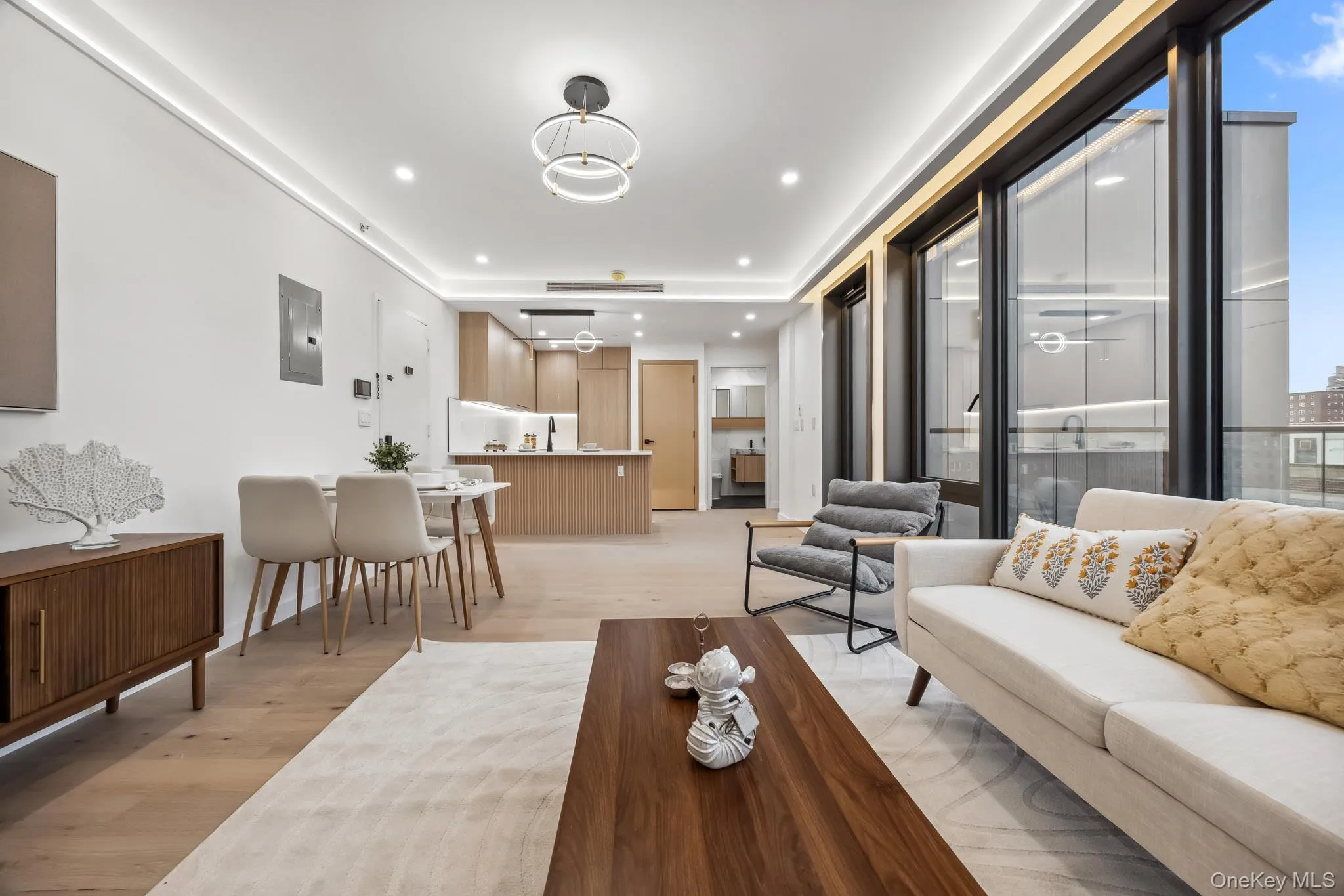 Living room featuring light wood finished floors, recessed lighting, and electric panel Living room featuring light wood finished floors, recessed lighting, and electric panel