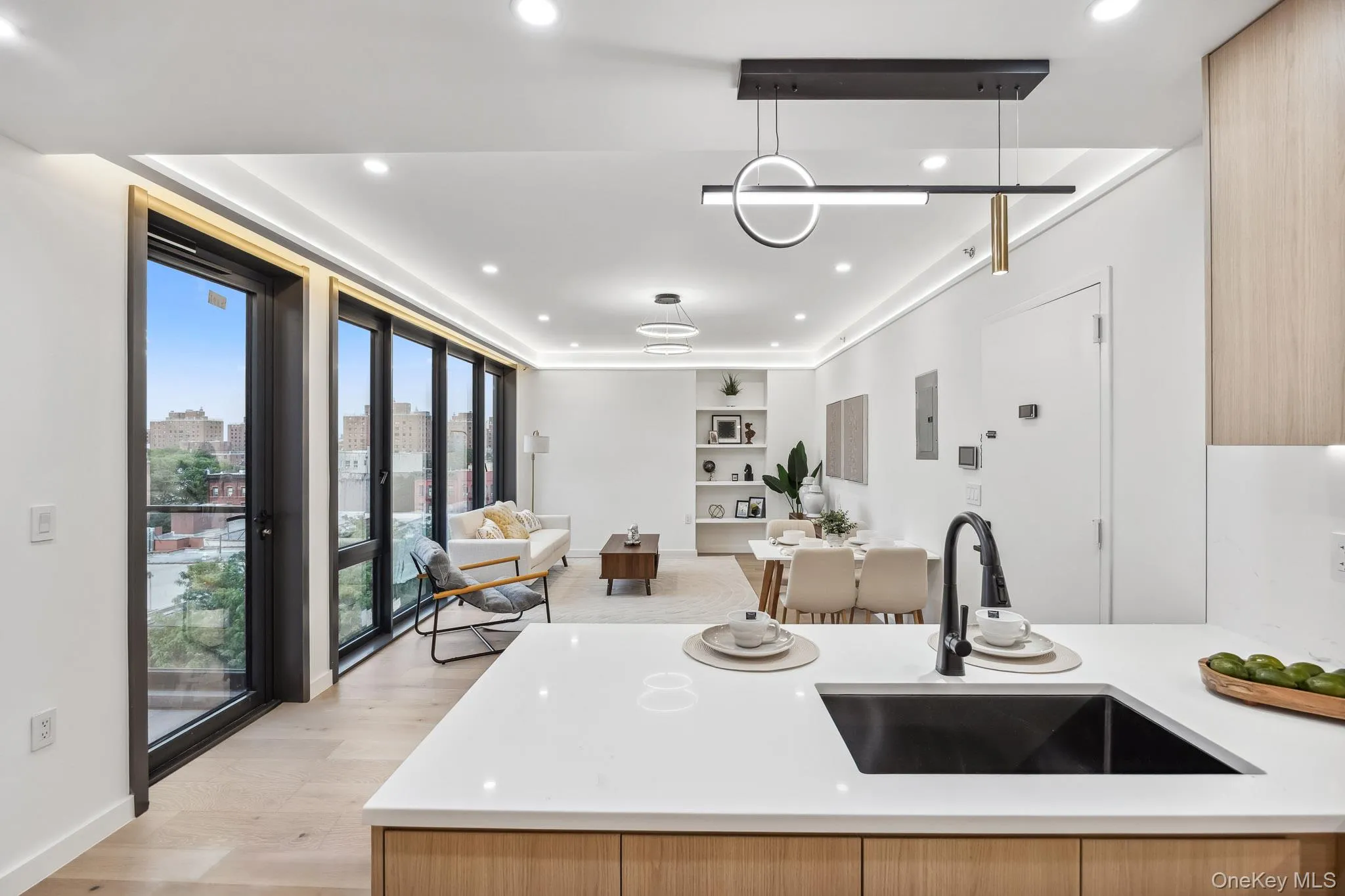 Kitchen with a sink, plenty of natural light, open floor plan, light countertops, and recessed lighting Kitchen with a sink, plenty of natural light, open floor plan, light countertops, and recessed lighting