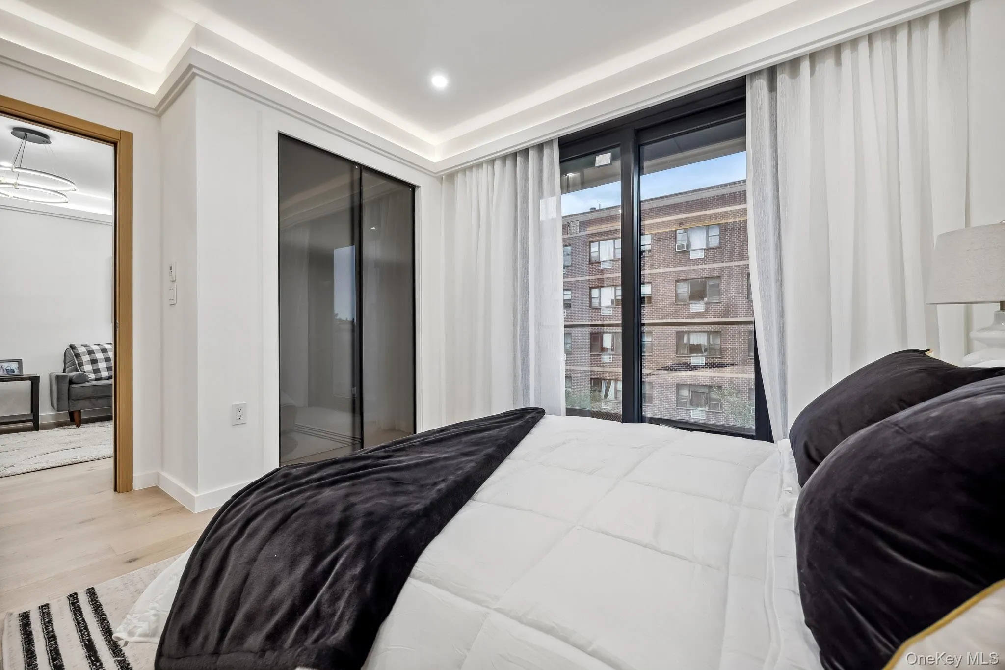 Bedroom with wood finished floors, a closet, and baseboards Bedroom with wood finished floors, a closet, and baseboards
