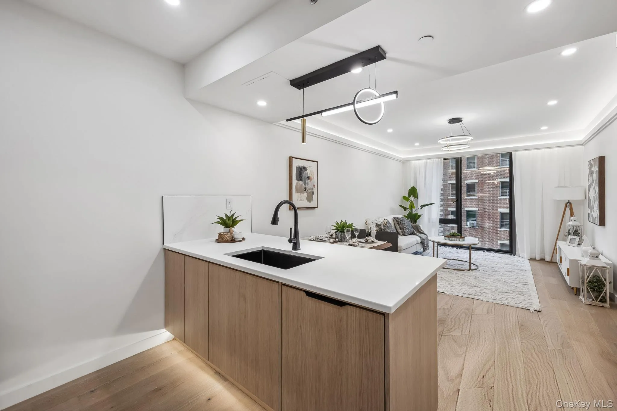 Kitchen with a sink, modern cabinets, a peninsula, light wood-type flooring, and recessed lighting Kitchen with a sink, modern cabinets, a peninsula, light wood-type flooring, and recessed lighting