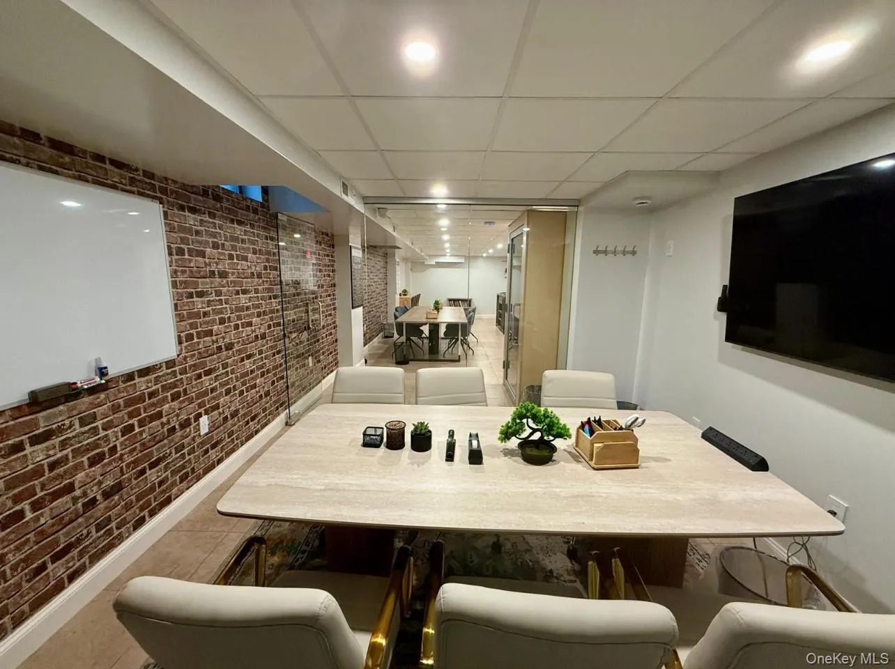Dining space with brick wall and a paneled ceiling Dining space with brick wall and a paneled ceiling