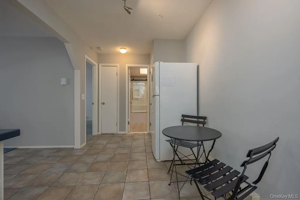 View from kitchen into hallway with bathroom and bedroom. View from kitchen into hallway with bathroom and bedroom.