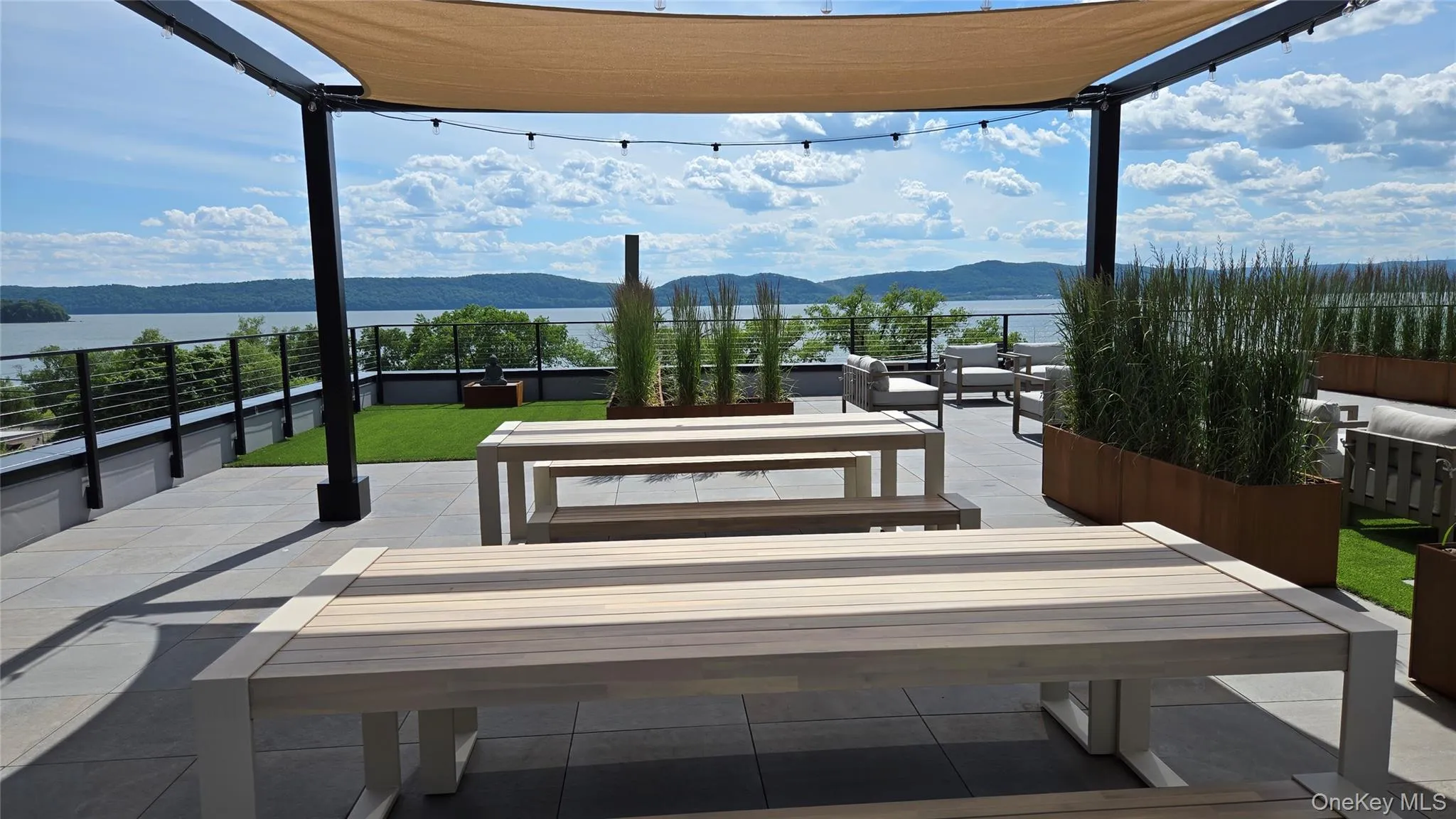 Alfresco dining under shade sails and string lights, with sweeping river and hillside views. Alfresco dining under shade sails and string lights, with sweeping river and hillside views.