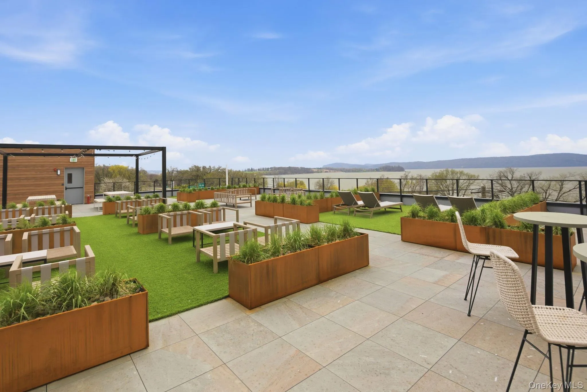 Rooftop oasis offering sweeping Hudson River views, thoughtfully designed with multiple seating areas and open-air gathering spaces. Rooftop oasis offering sweeping Hudson River views, thoughtfully designed with multiple seating areas and open-air gathering spaces.