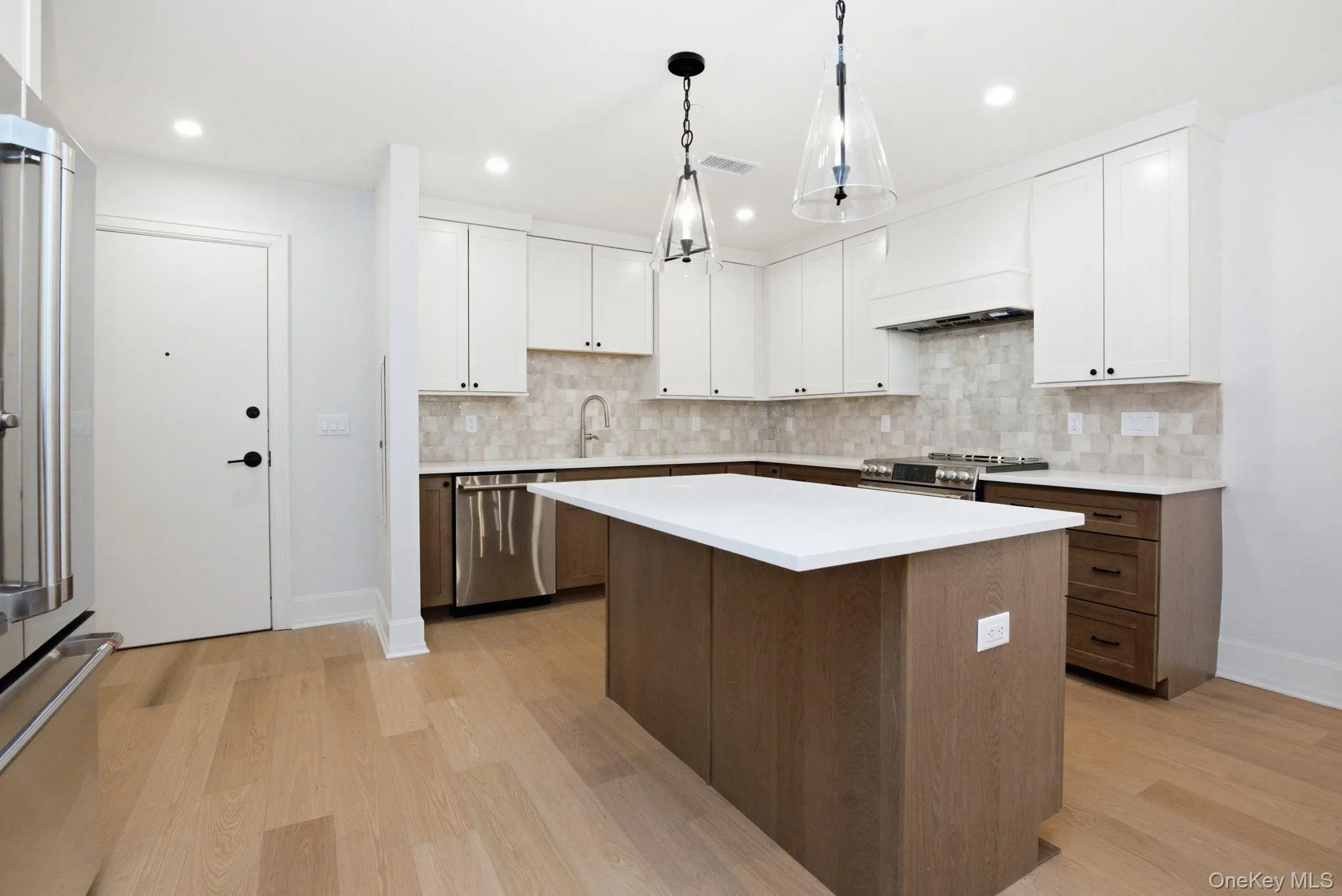 Designer kitchen showcasing a full-height tile backsplash, modern hardware, and carefully selected finishes throughout. Designer kitchen showcasing a full-height tile backsplash, modern hardware, and carefully selected finishes throughout.