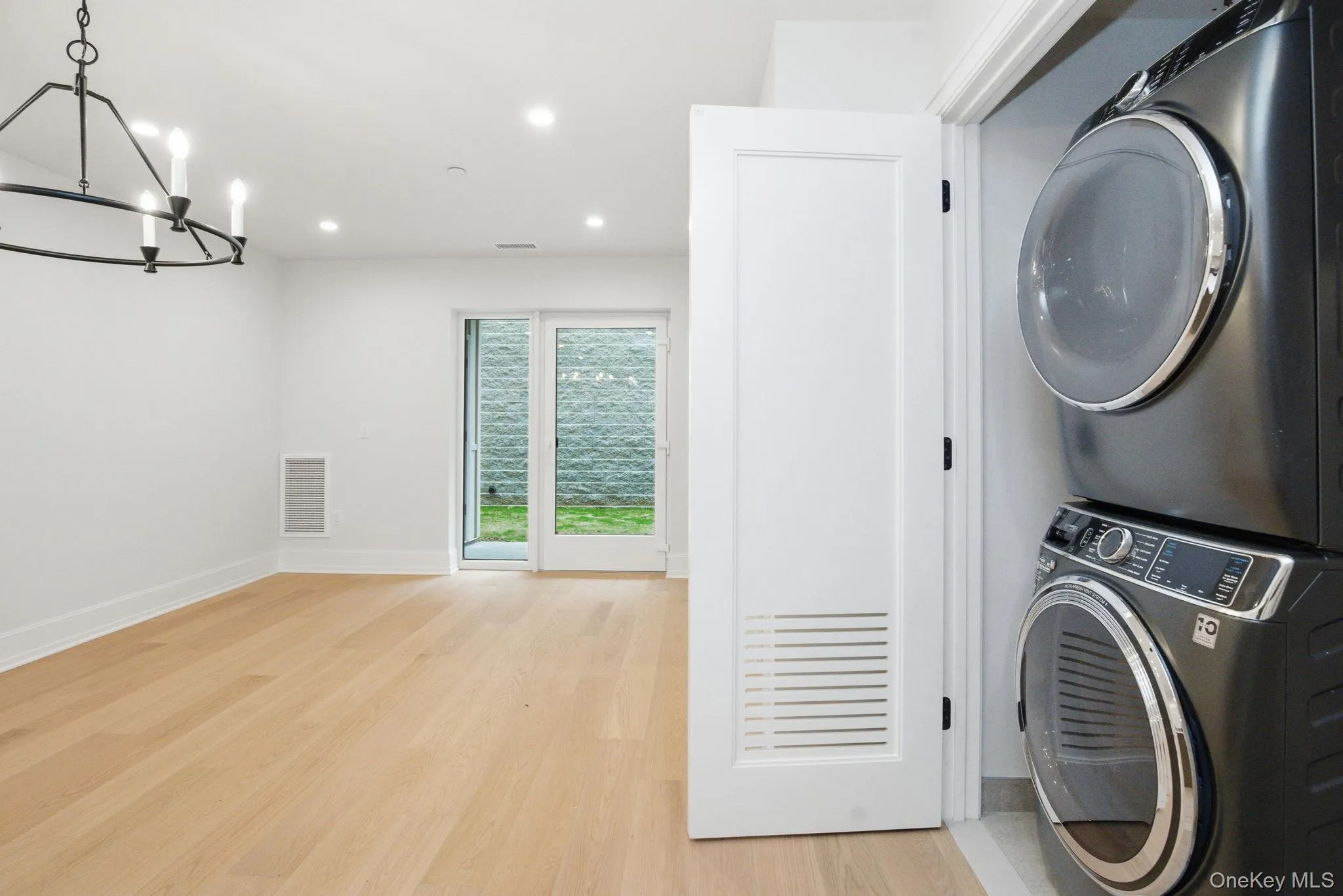 In-unit laundry with stacked washer and dryer discreetly integrated for everyday convenience. In-unit laundry with stacked washer and dryer discreetly integrated for everyday convenience.