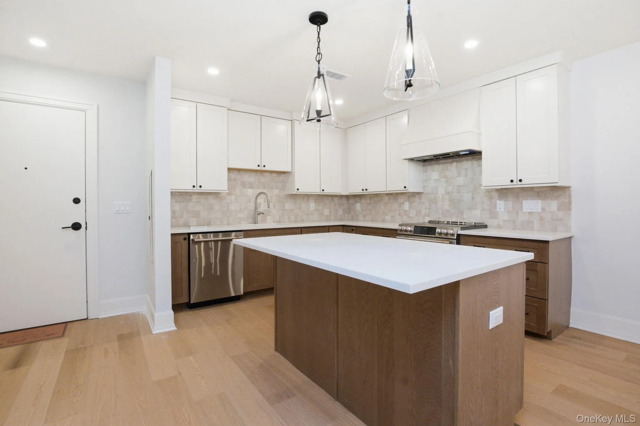 Thoughtfully designed kitchen featuring a generous center island, custom cabinetry, and a seamless blend of warm wood tones and crisp finishes Thoughtfully designed kitchen featuring a generous center island, custom cabinetry, and a seamless blend of warm wood tones and crisp finishes
