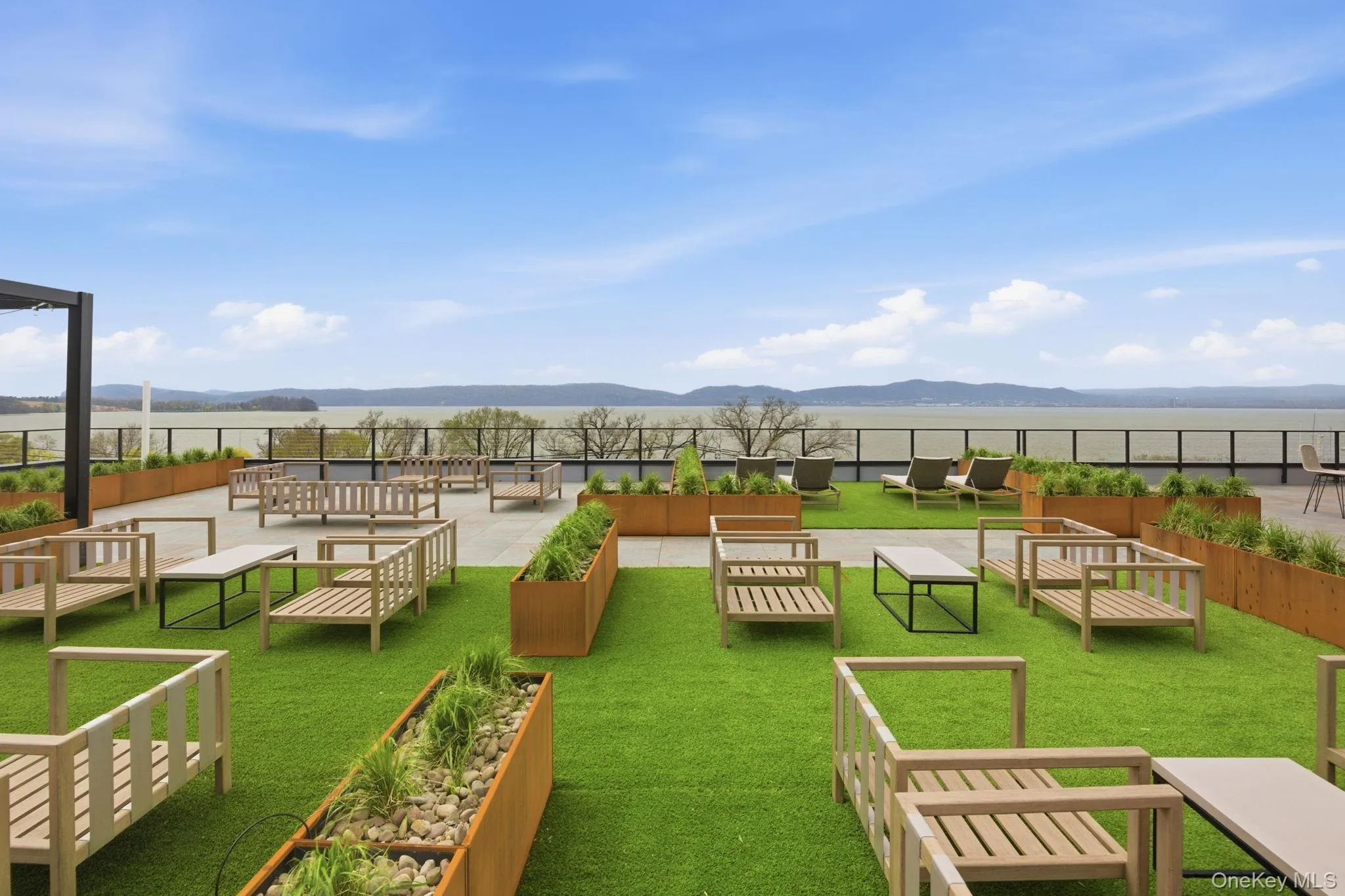 Expansive rooftop terrace featuring landscaped lounging areas, creating an elevated setting for relaxation and entertaining. Expansive rooftop terrace featuring landscaped lounging areas, creating an elevated setting for relaxation and entertaining.
