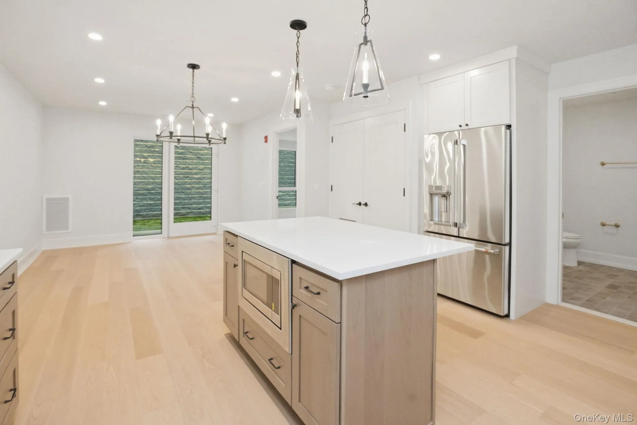 Chef-inspired kitchen featuring a substantial center island with integrated microwave, ideal for both preparation and entertaining. Chef-inspired kitchen featuring a substantial center island with integrated microwave, ideal for both preparation and entertaining.