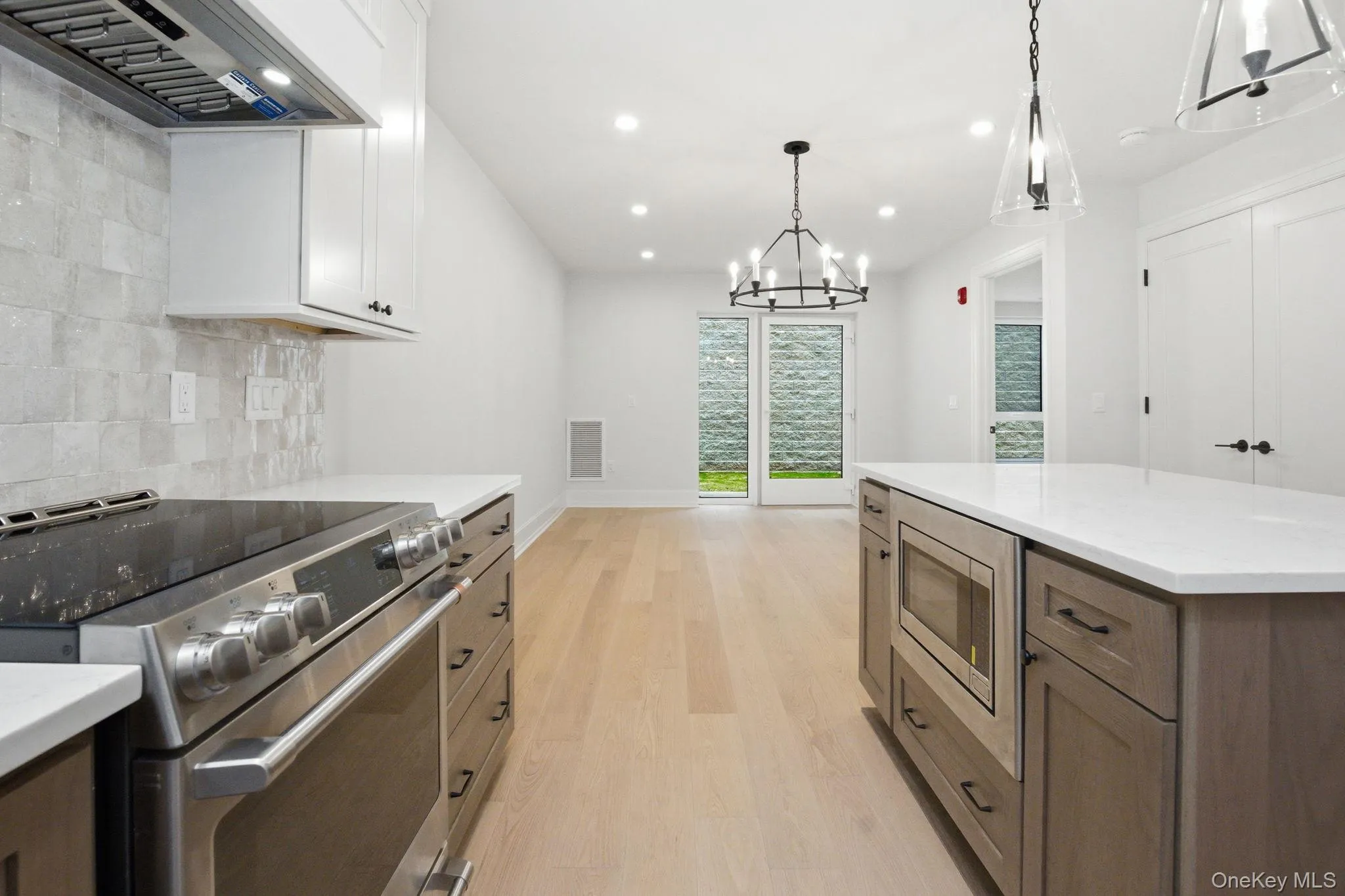 Premium GE Café appliances complement custom cabinetry and sleek quartz countertops, creating a refined and highly functional workspace. Premium GE Café appliances complement custom cabinetry and sleek quartz countertops, creating a refined and highly functional workspace.