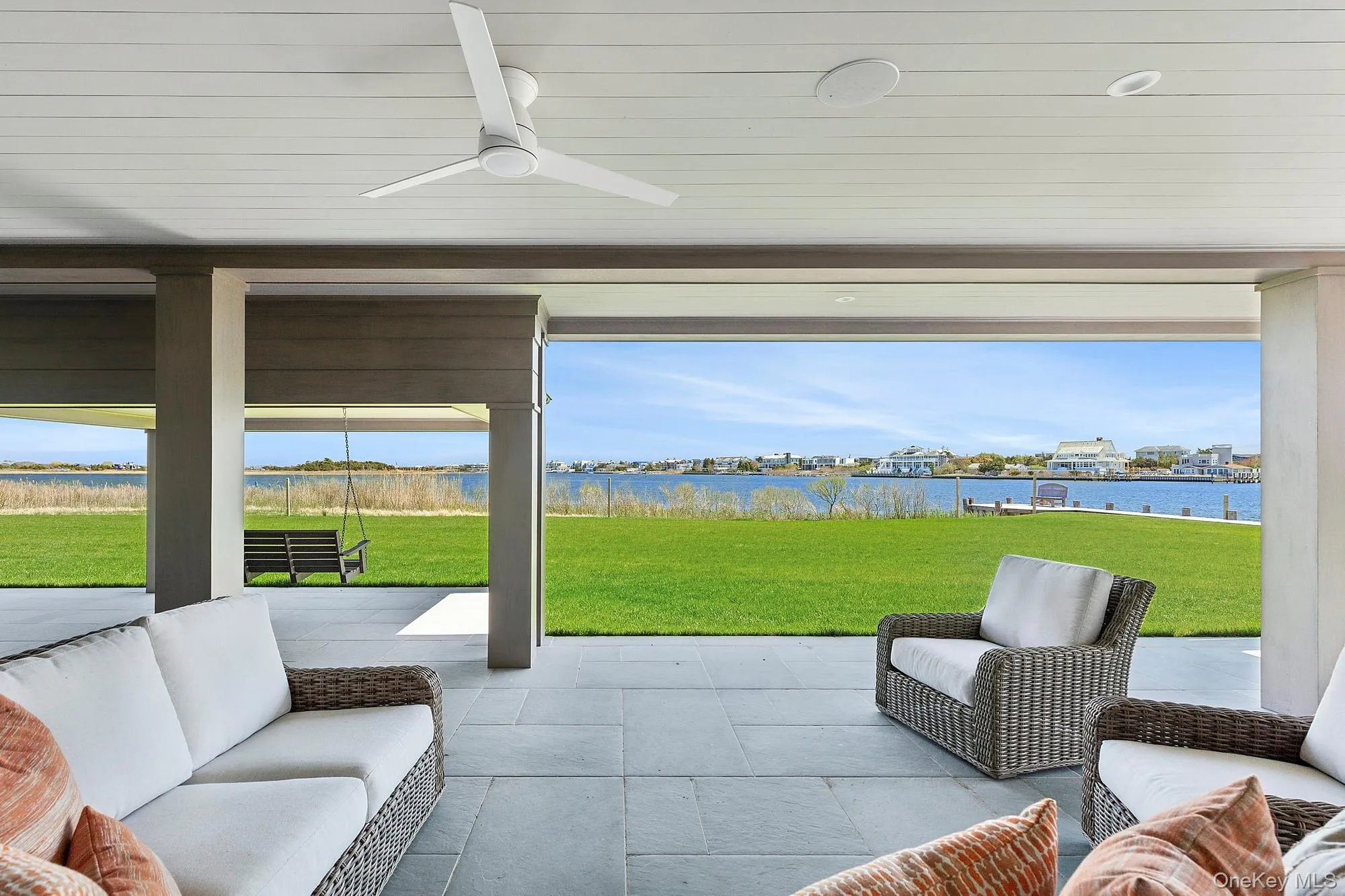 Sunroom / solarium featuring a water view, outdoor lounge area, and a ceiling fan Sunroom / solarium featuring a water view, outdoor lounge area, and a ceiling fan