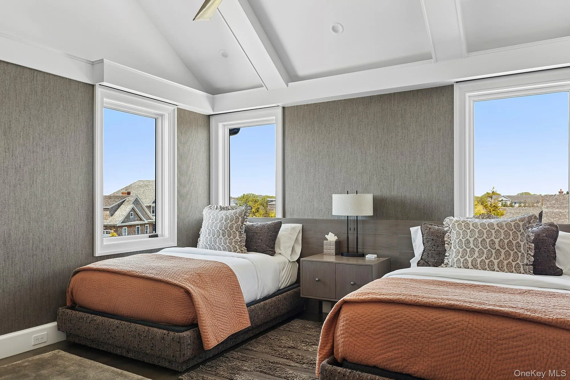 Bedroom with lofted ceiling, wallpapered walls, and wood finished floors Bedroom with lofted ceiling, wallpapered walls, and wood finished floors