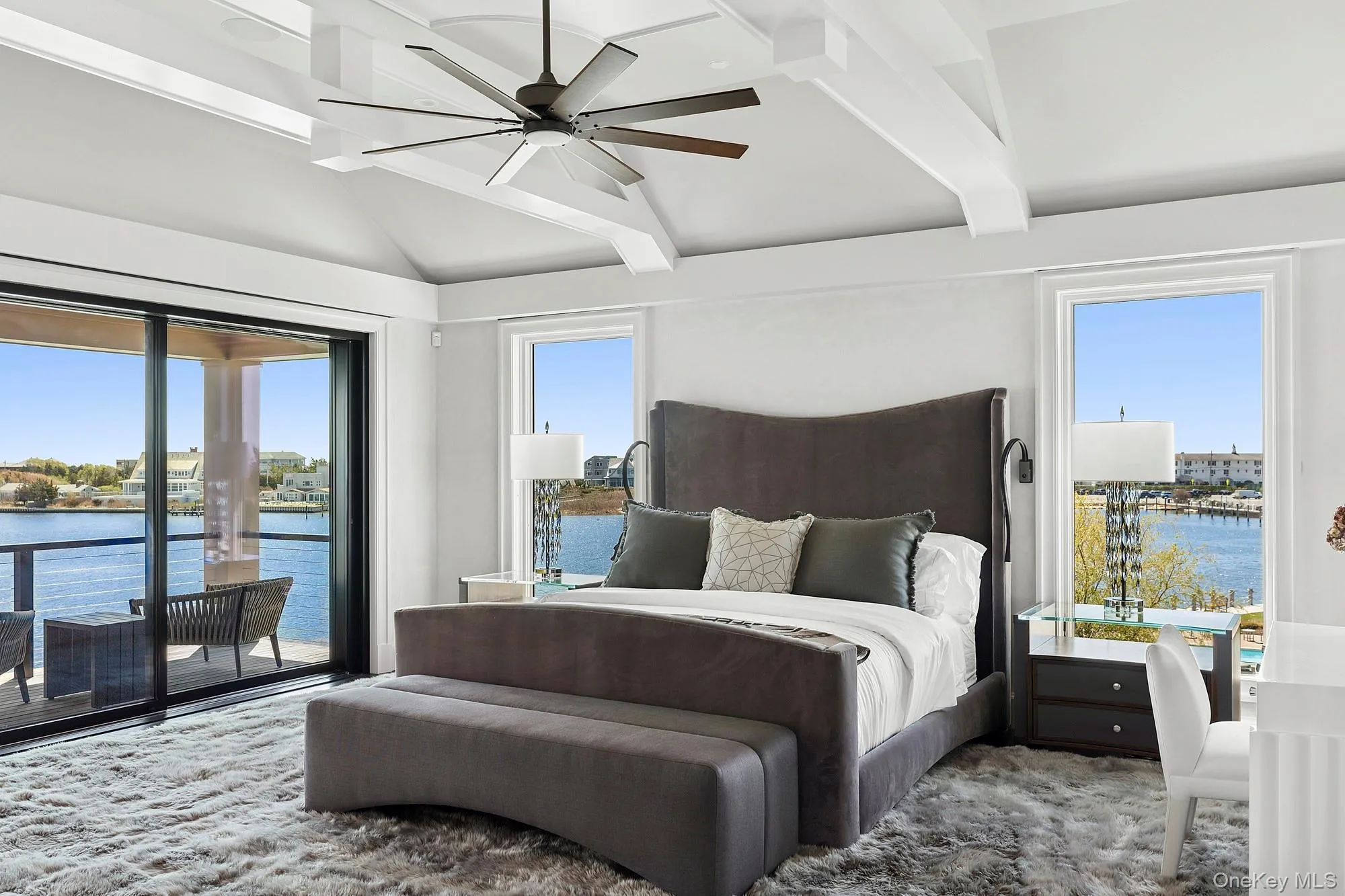 Bedroom featuring access to outside, a water view, and ceiling fan Bedroom featuring access to outside, a water view, and ceiling fan