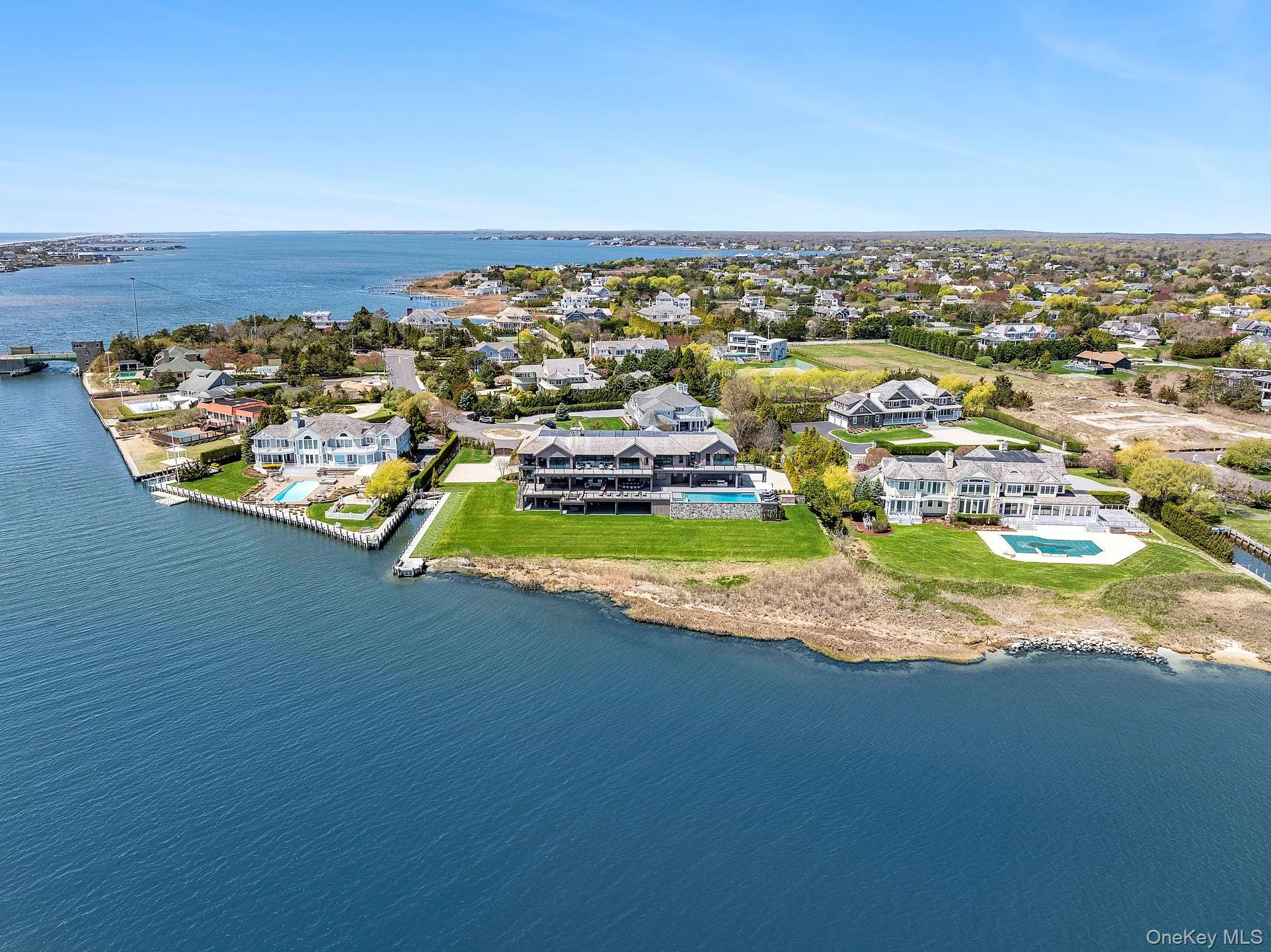 Aerial view of residential area featuring a large body of water Aerial view of residential area featuring a large body of water