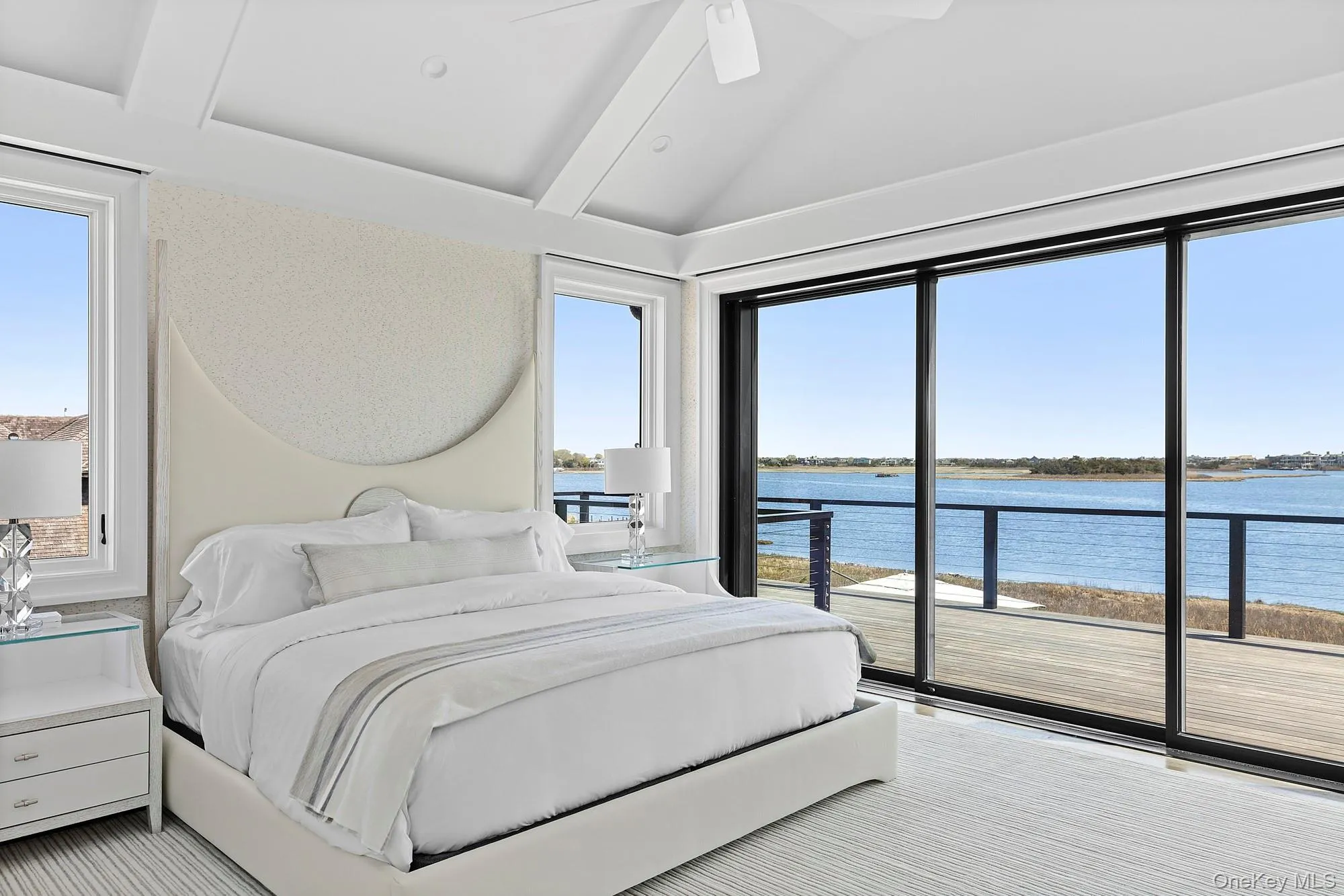 Bedroom featuring a water view, access to outside, and ceiling fan Bedroom featuring a water view, access to outside, and ceiling fan