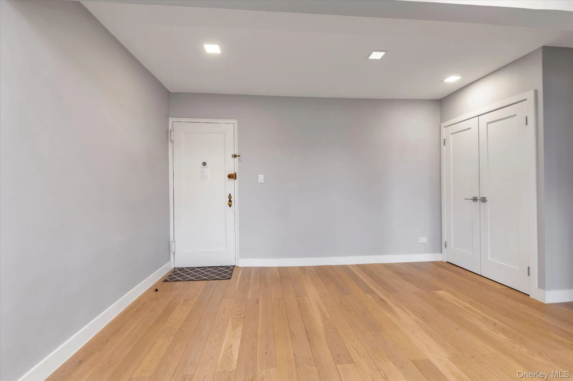 Foyer with light wood-type flooring, closet, and recessed lighting Foyer with light wood-type flooring, closet, and recessed lighting