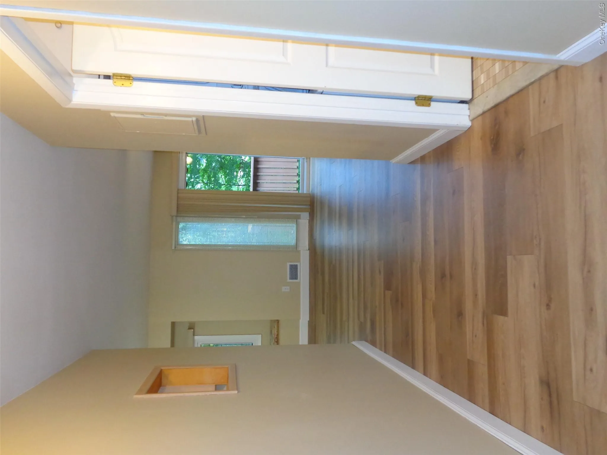 Hall leading to living room and dining room. All new flooring throughout. Hall leading to living room and dining room. All new flooring throughout.
