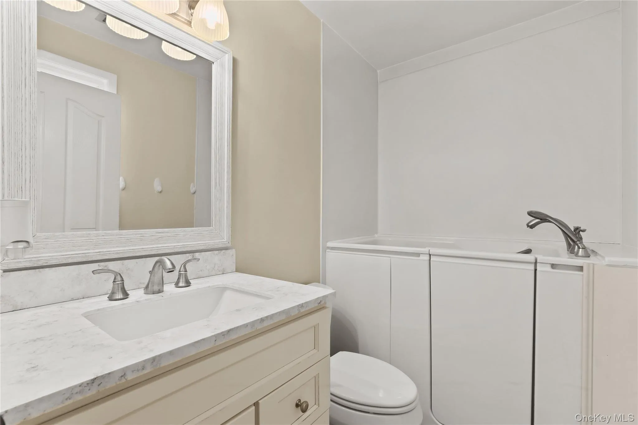 Updated primary bath with window. Walk in tub. Updated in (2021). Updated primary bath with window. Walk in tub. Updated in (2021).