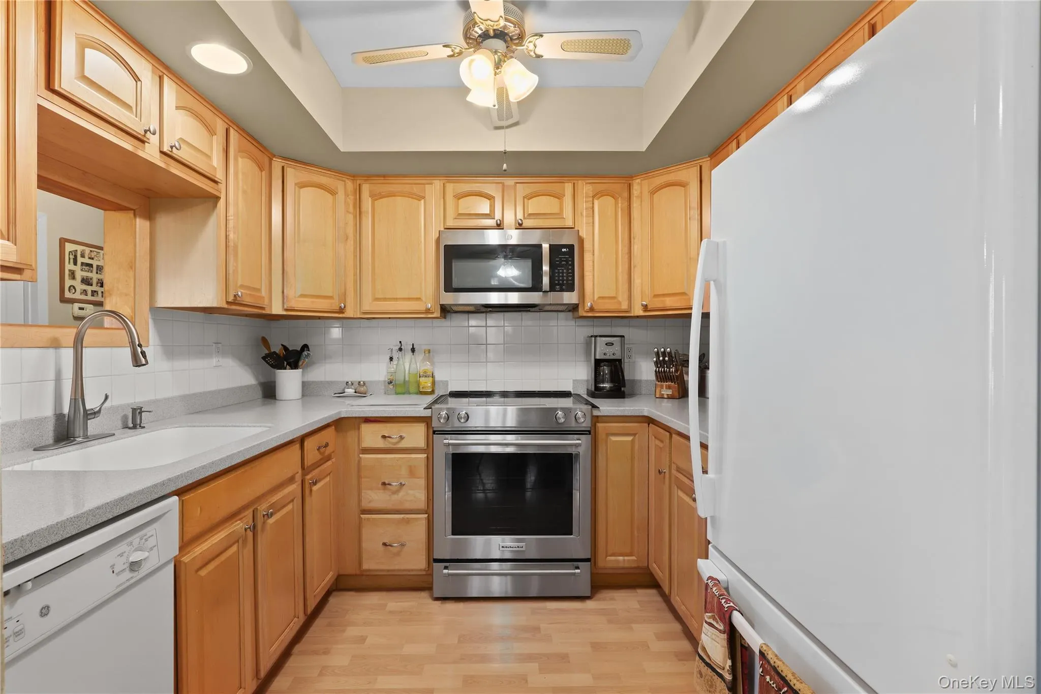 Beautiful, updated kitchen in (2003) Maple Cabinets, Corian countertops, dishwasher, microwave, and flooring. Recessed lighting over your spacious countertops. Ceiling fan. 5 Ceiling fans are included with this spacious unit. Tile back splash. There is an easy pass through, for light and convenience. Beautiful, updated kitchen in (2003) Maple Cabinets, Corian countertops, dishwasher, microwave, and flooring. Recessed lighting over your spacious countertops. Ceiling fan. 5 Ceiling fans are included with this spacious unit. Tile back splash. There is an easy pass through, for light and convenience.