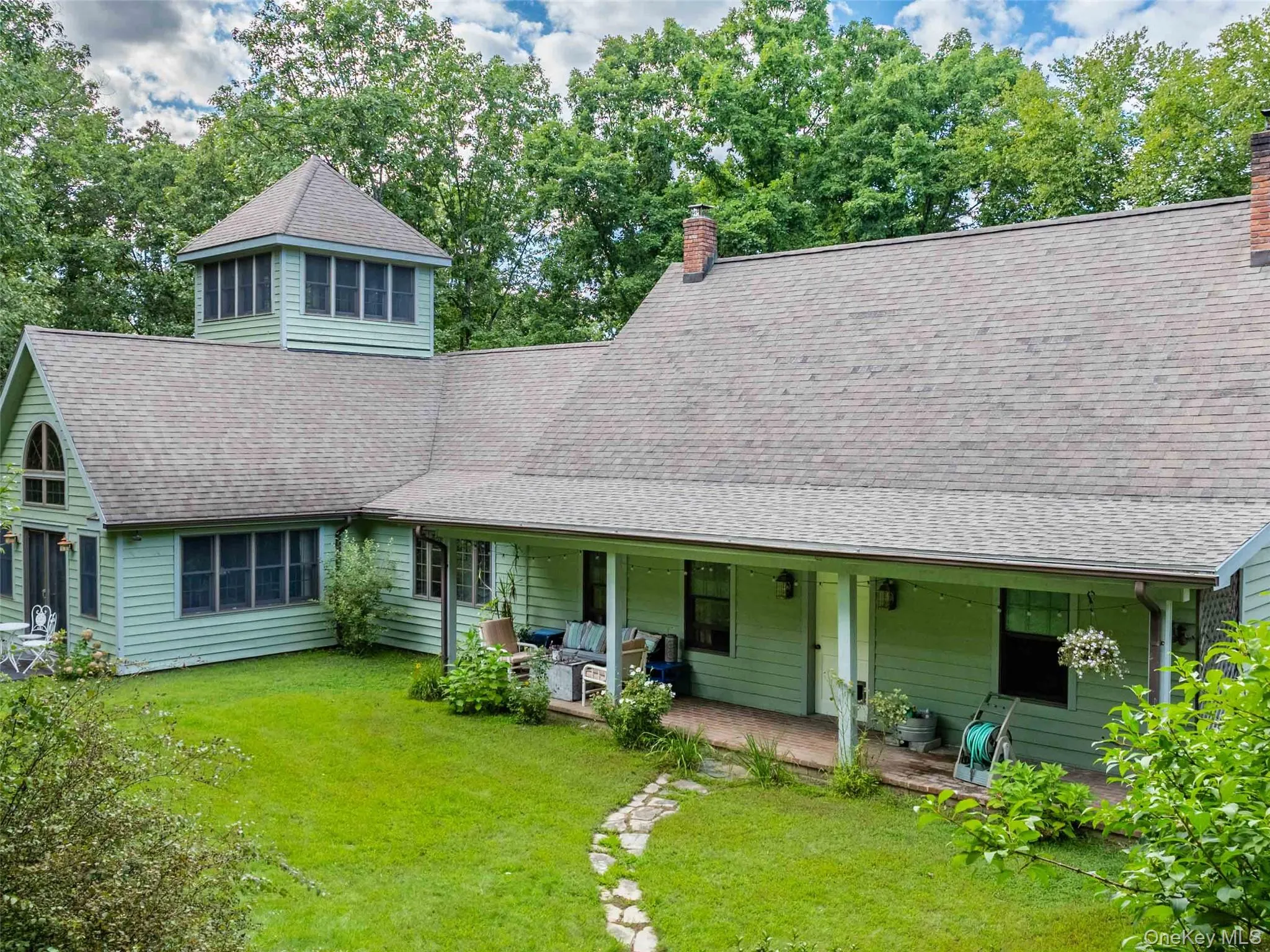 View of front of property with a chimney and roof with shingles View of front of property with a chimney and roof with shingles