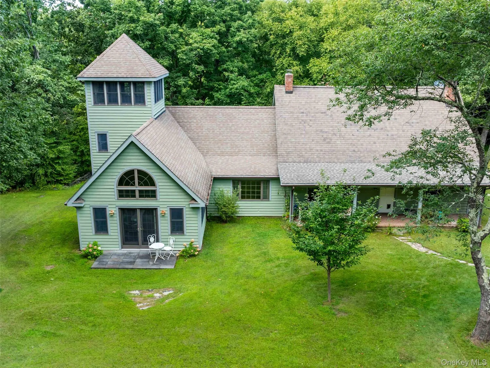 Rear view of property with roof with shingles, a yard, a patio area, and a chimney Rear view of property with roof with shingles, a yard, a patio area, and a chimney