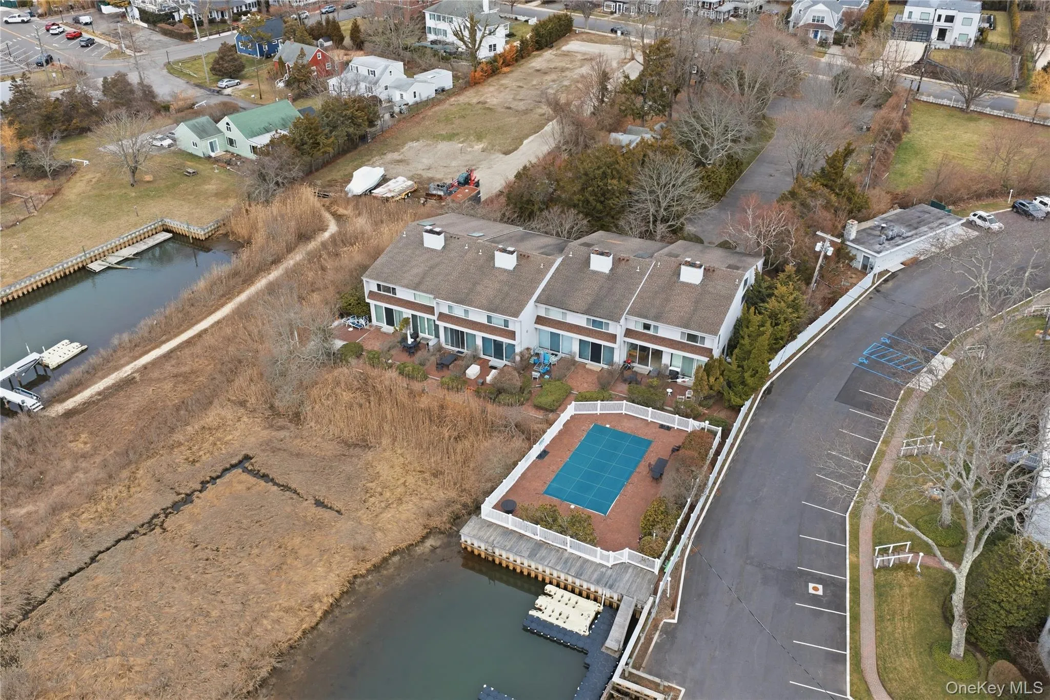 Aerial overview of property's location with a nearby body of water and nearby suburban area Aerial overview of property's location with a nearby body of water and nearby suburban area