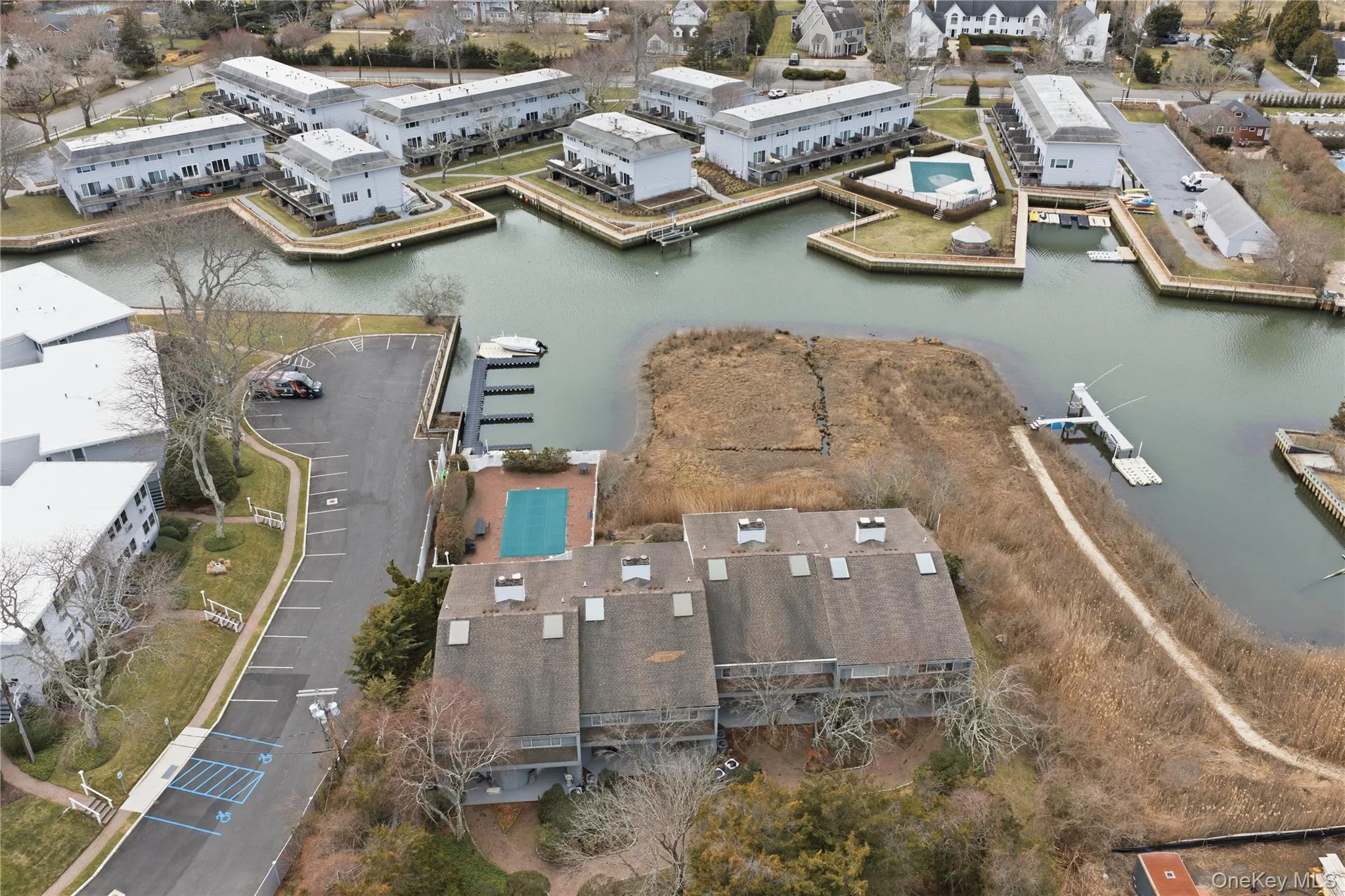 Drone / aerial view of a nearby body of water, pool, and dock Drone / aerial view of a nearby body of water, pool, and dock