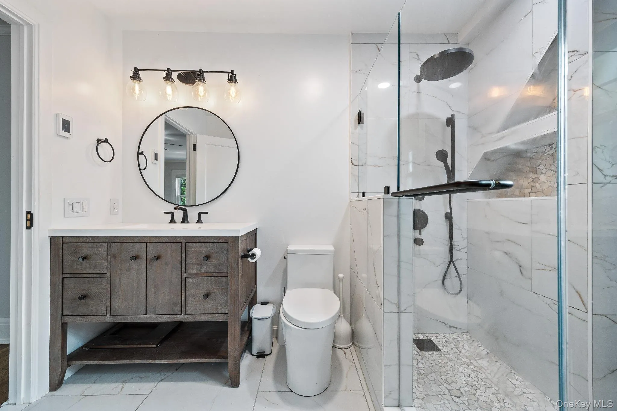 Bathroom with a marble finish shower and vanity Bathroom with a marble finish shower and vanity