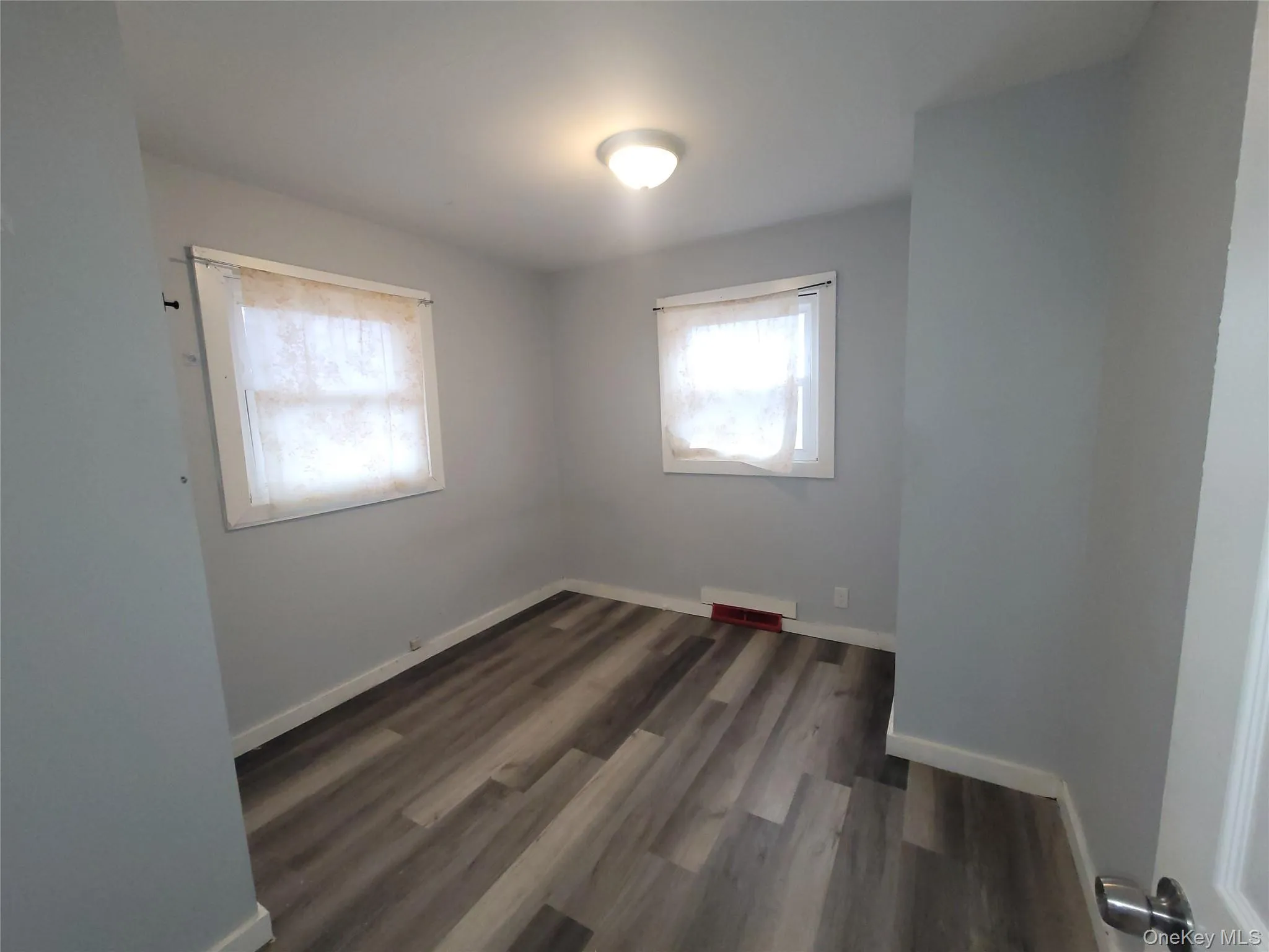 Empty bedroom with vinyl laminate finished floors. Empty bedroom with vinyl laminate finished floors.