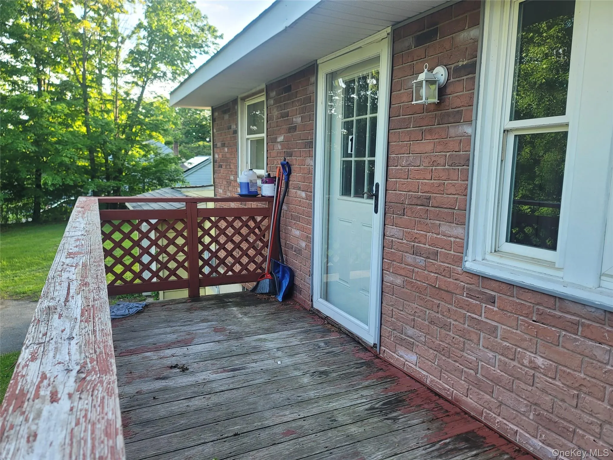 Outdoor deck area featuring a red lattice railing Outdoor deck area featuring a red lattice railing