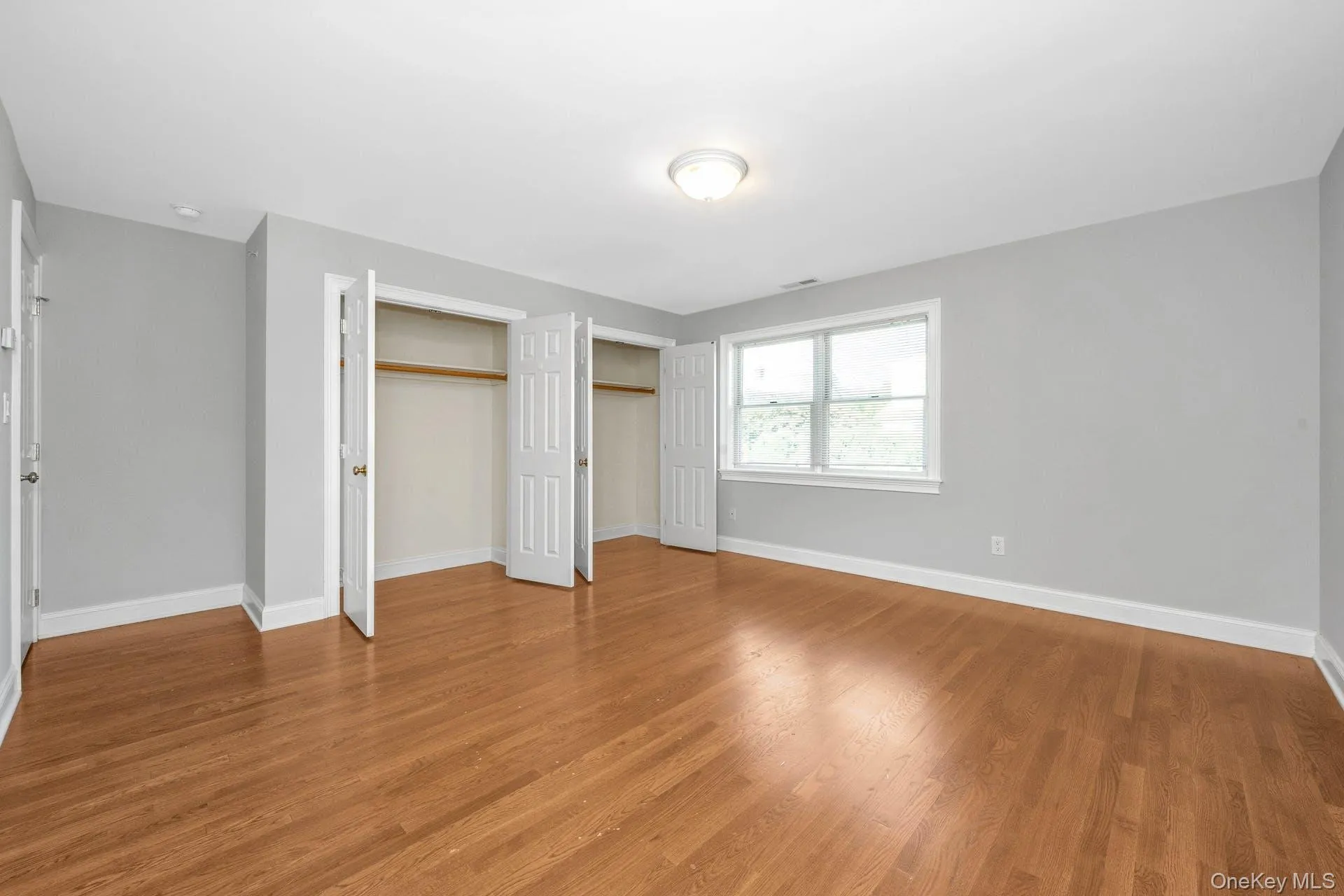 Unfurnished bedroom featuring light wood-style flooring Unfurnished bedroom featuring light wood-style flooring