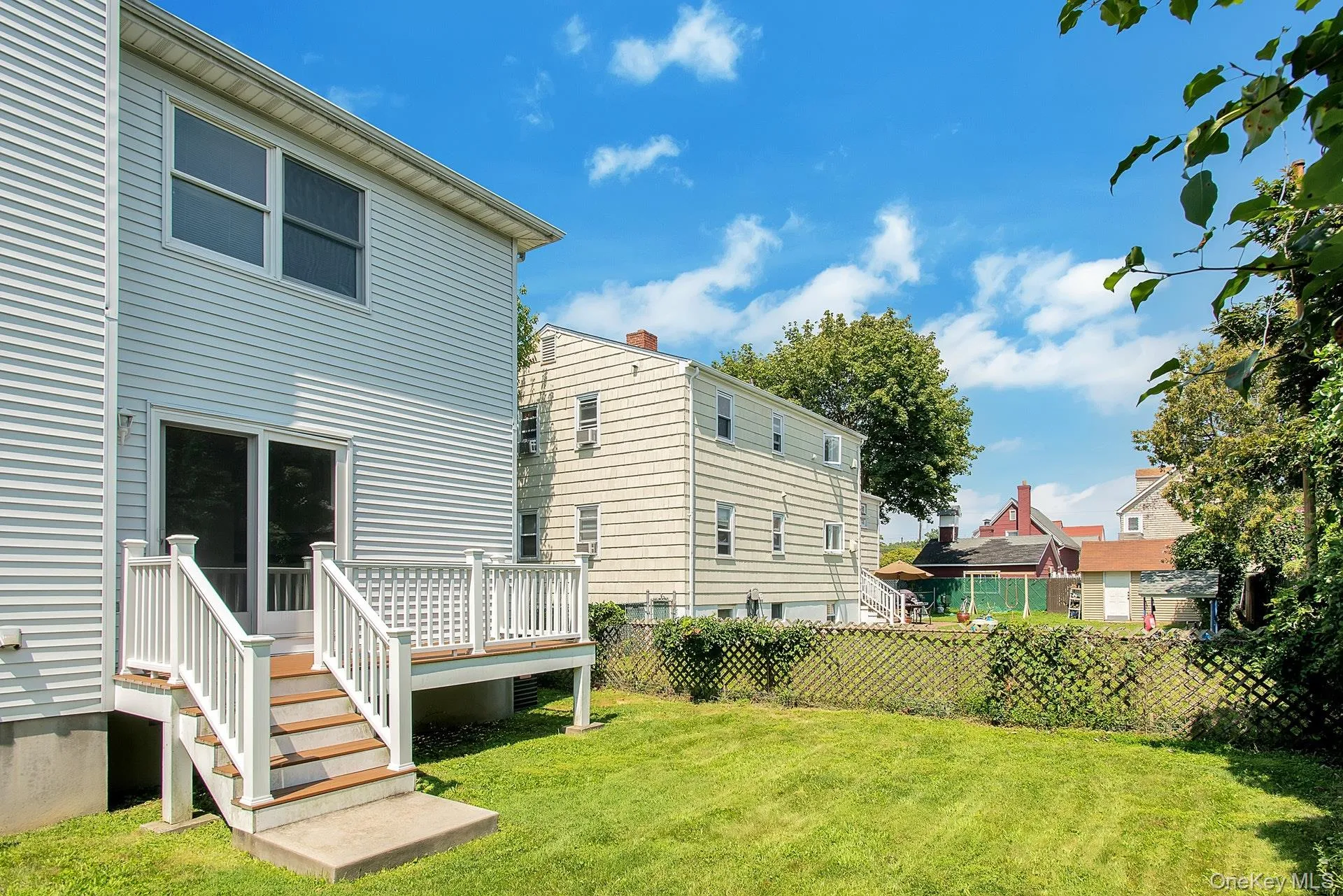 View of yard with a wooden deck View of yard with a wooden deck