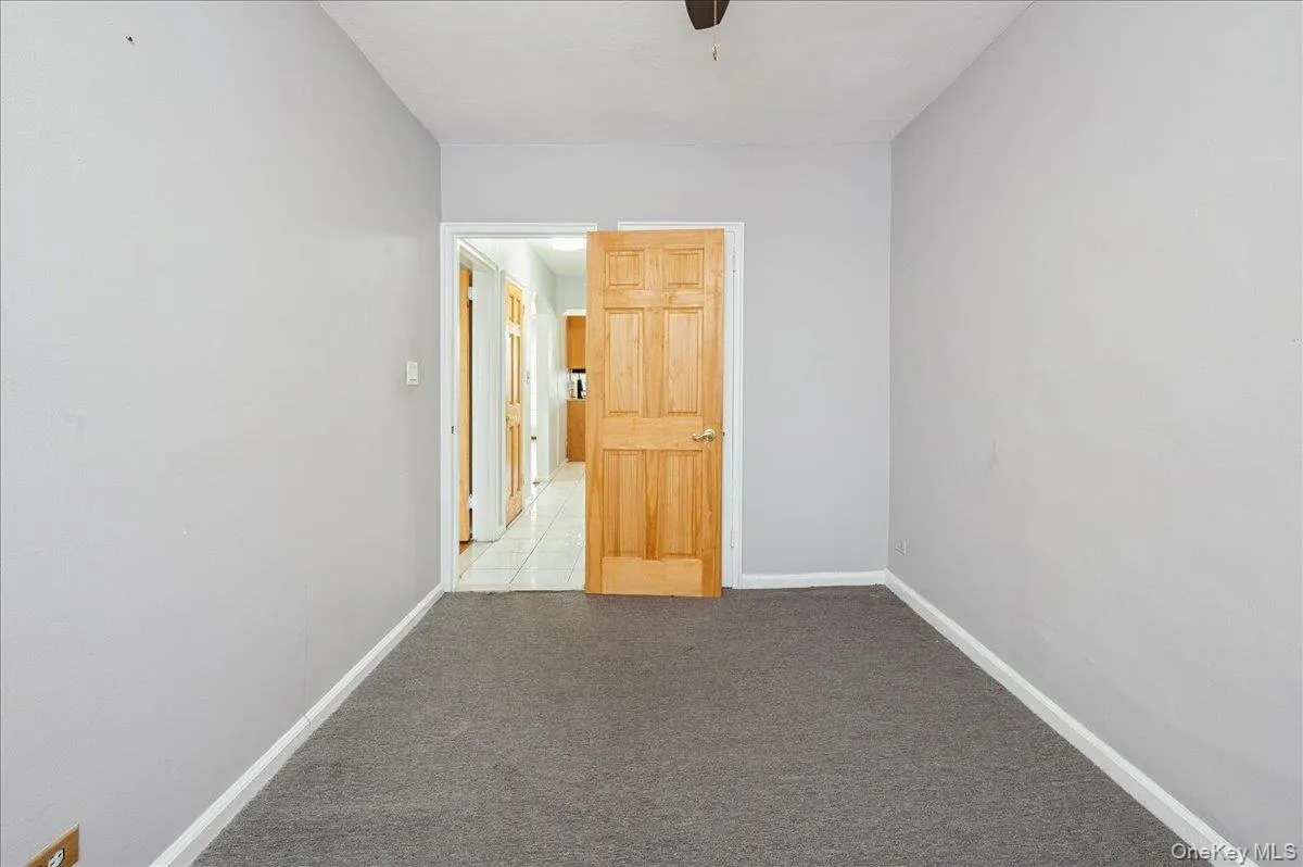 Second bedroom featuring light carpet and baseboards Second bedroom featuring light carpet and baseboards