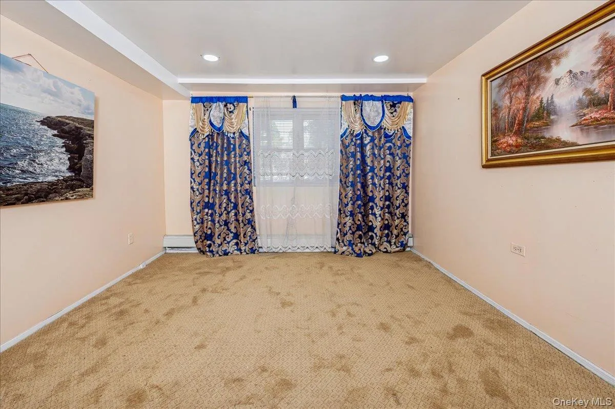 Carpeted third bedroom with baseboards (on first floor) Carpeted third bedroom with baseboards (on first floor)