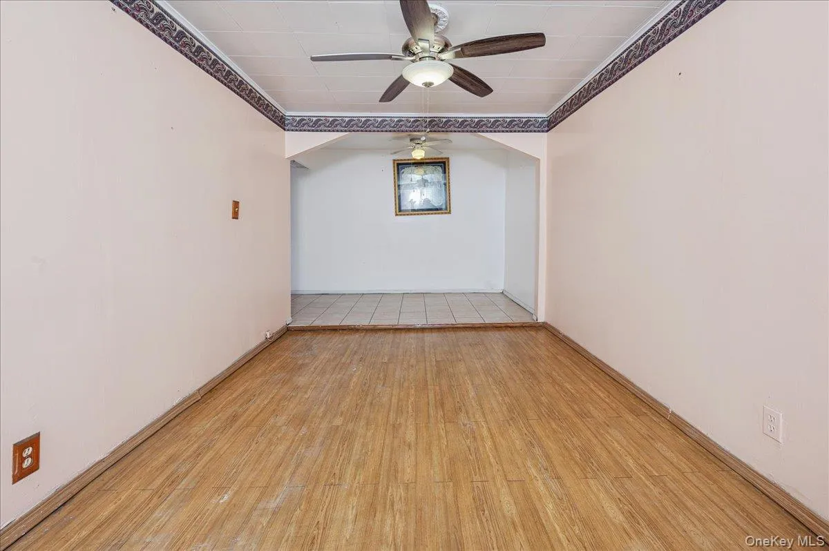 Family room featuring ceiling fan, light wood -type finished floors, and crown molding Family room featuring ceiling fan, light wood -type finished floors, and crown molding