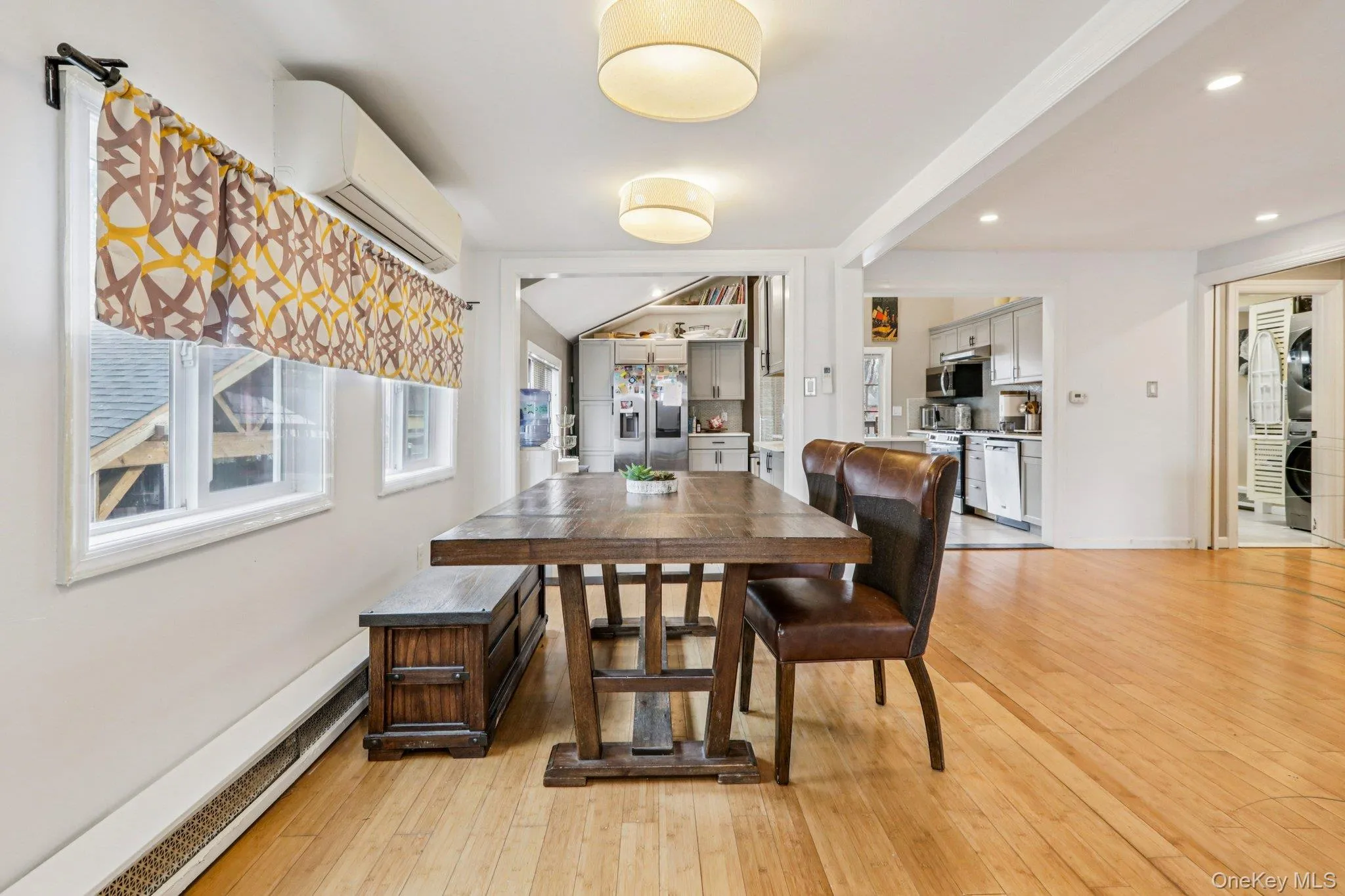 Dining space featuring light wood-style floors, a baseboard heating Dining space featuring light wood-style floors, a baseboard heating