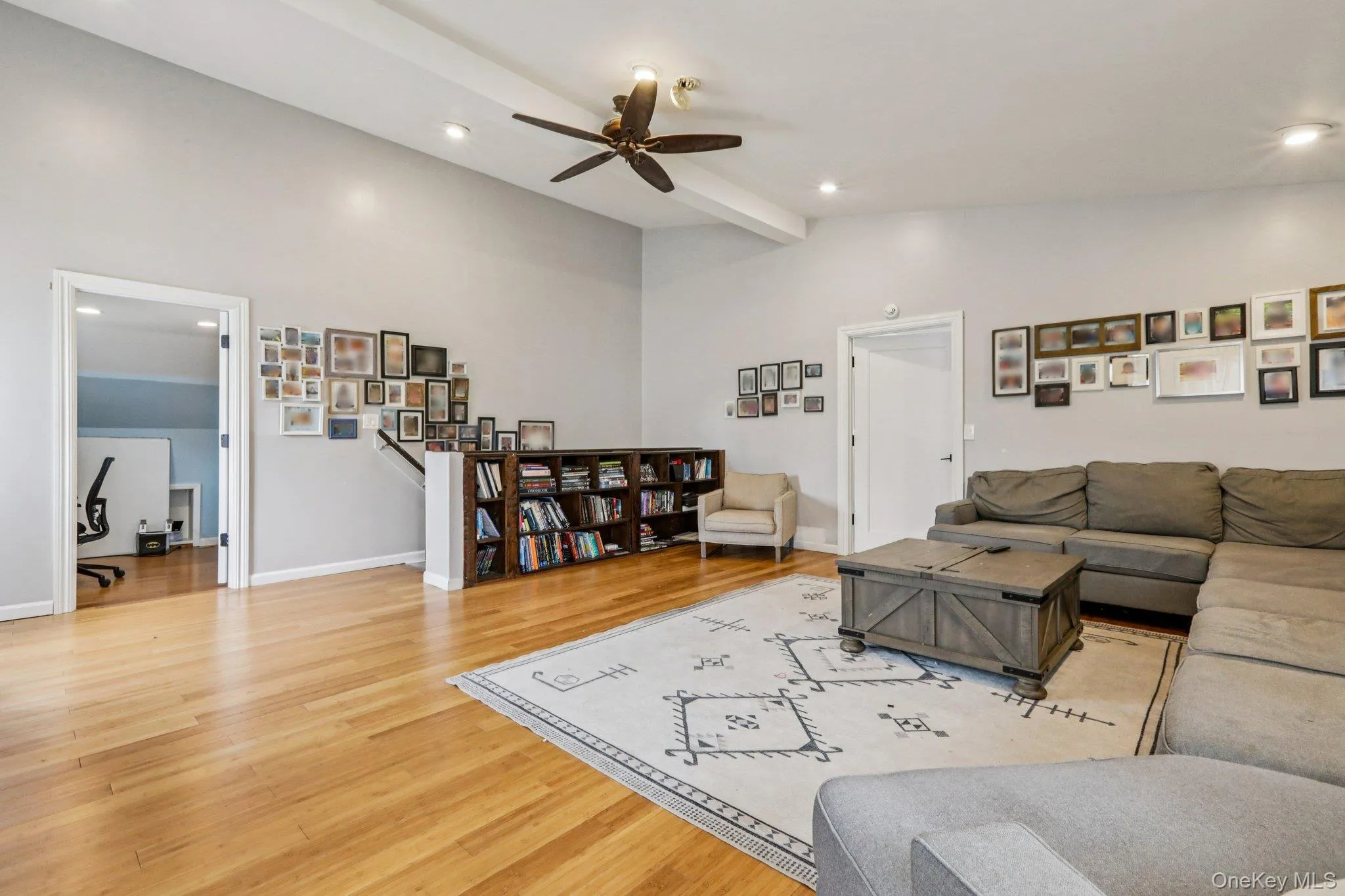 Family room featuring light wood-type flooring, recessed lighting, ceiling fan, and vaulted ceiling with beams Family room featuring light wood-type flooring, recessed lighting, ceiling fan, and vaulted ceiling with beams