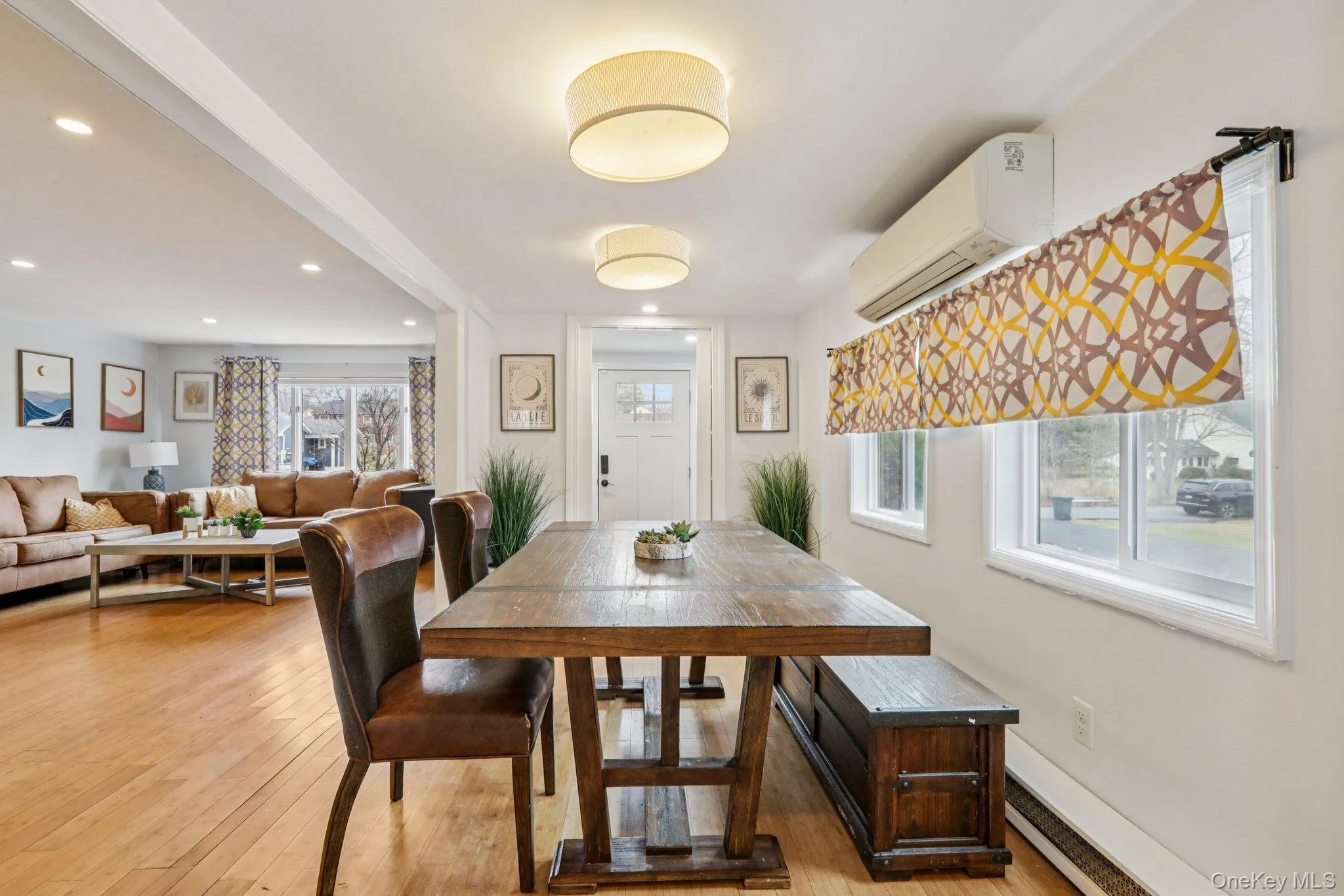 Dining area with light wood-style floors and recessed lighting Dining area with light wood-style floors and recessed lighting