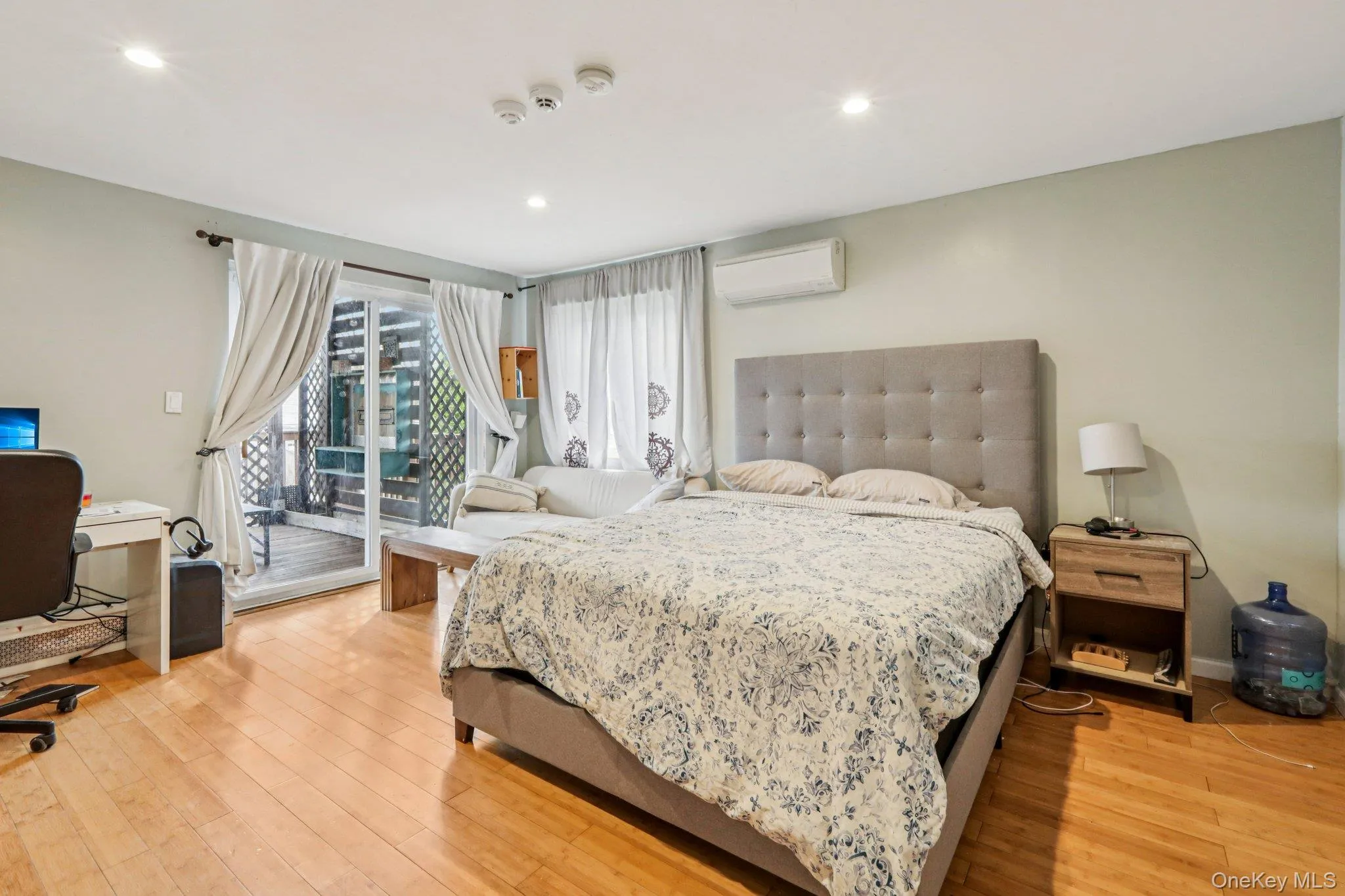 Primary Bedroom access to deck outside, light wood-style floors, and recessed lighting Primary Bedroom access to deck outside, light wood-style floors, and recessed lighting