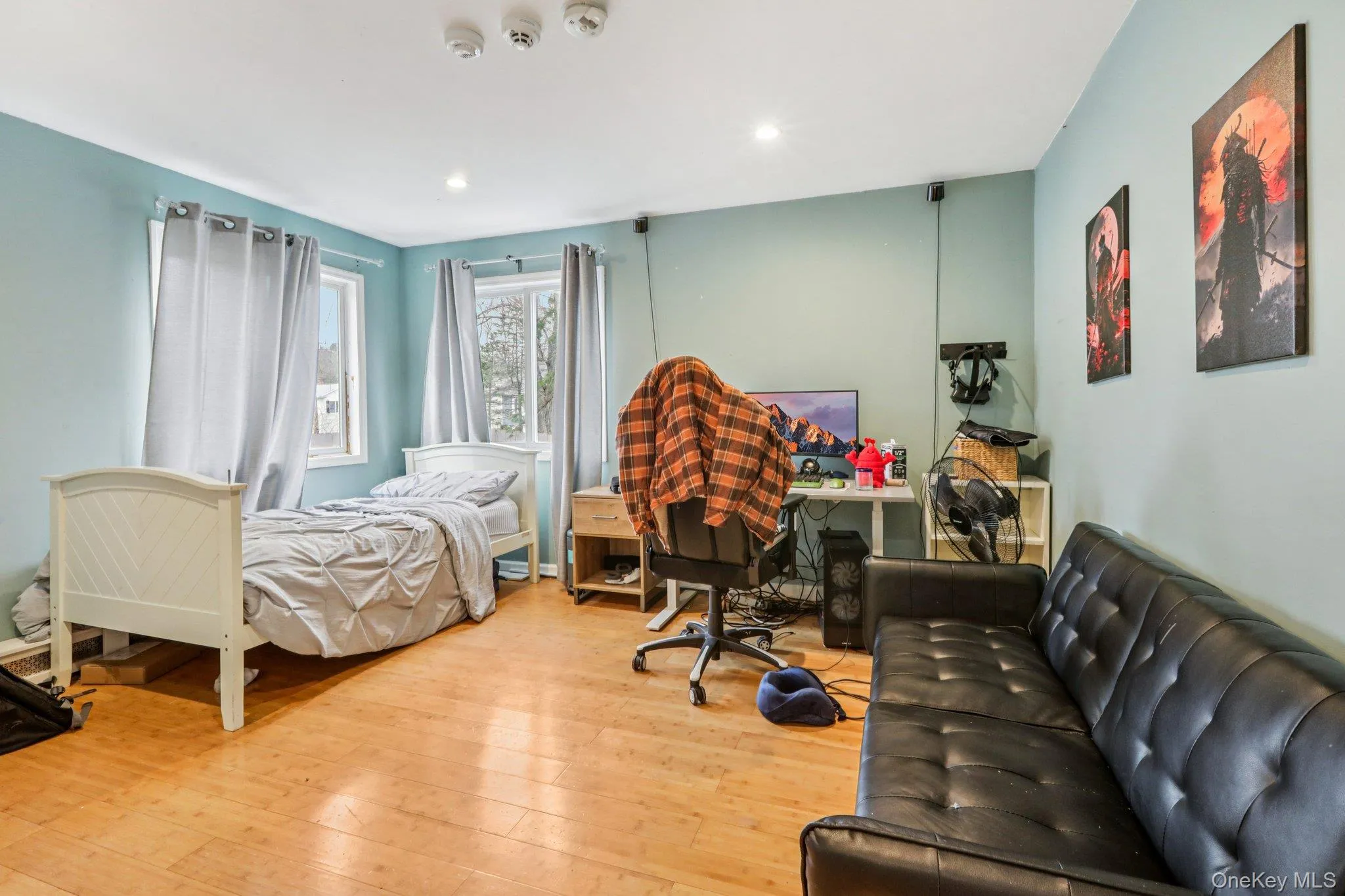 Bedroom with light wood-type flooring and recessed lighting Bedroom with light wood-type flooring and recessed lighting