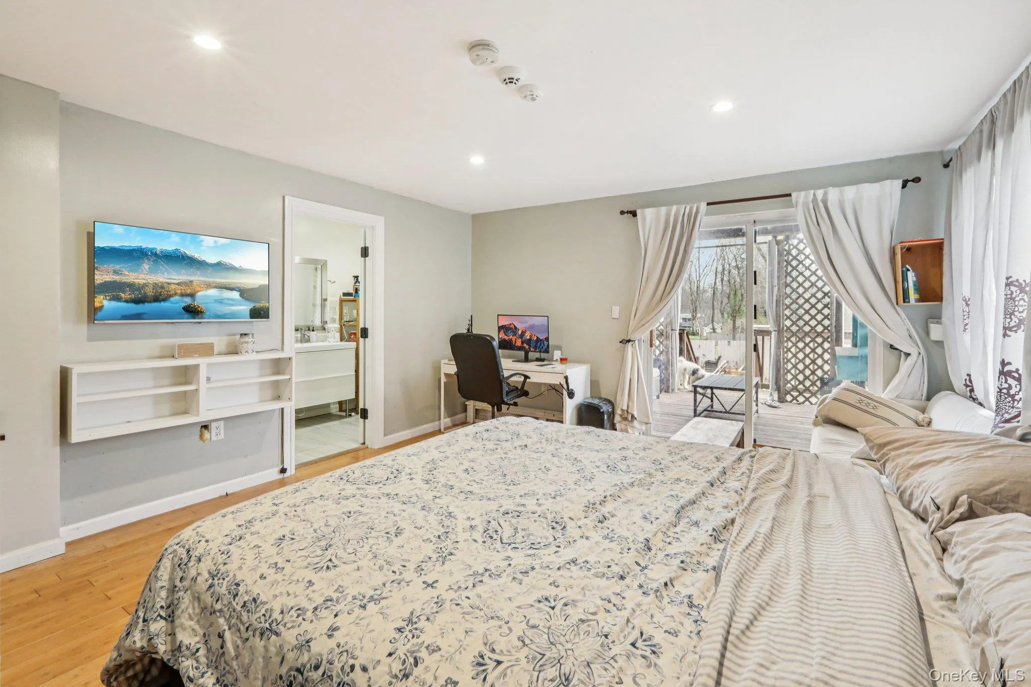 Primary Bedroom access to outside, light wood-style flooring, recessed lighting, and ensuite bath Primary Bedroom access to outside, light wood-style flooring, recessed lighting, and ensuite bath