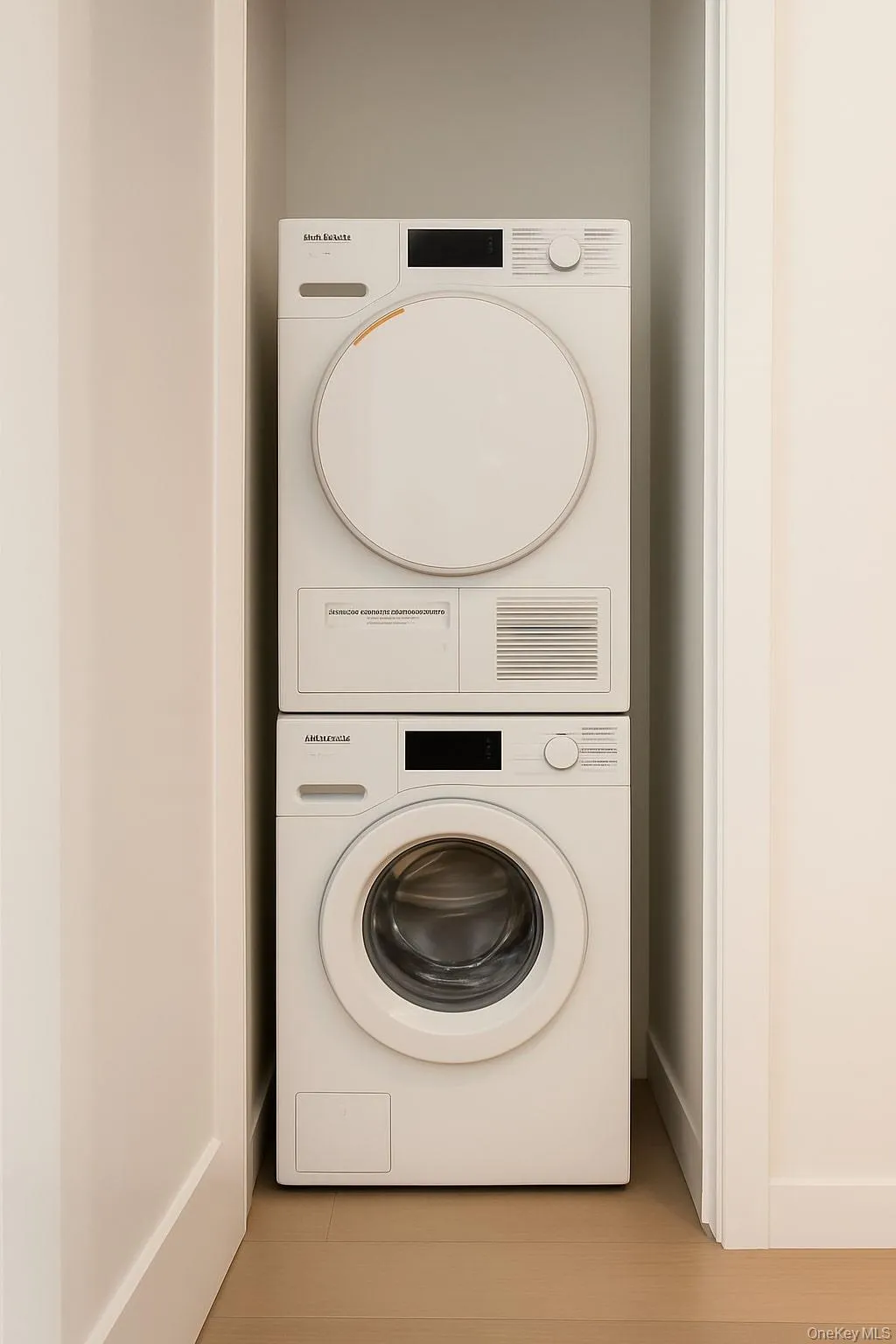 Laundry area featuring stacked washer / dryer Laundry area featuring stacked washer / dryer