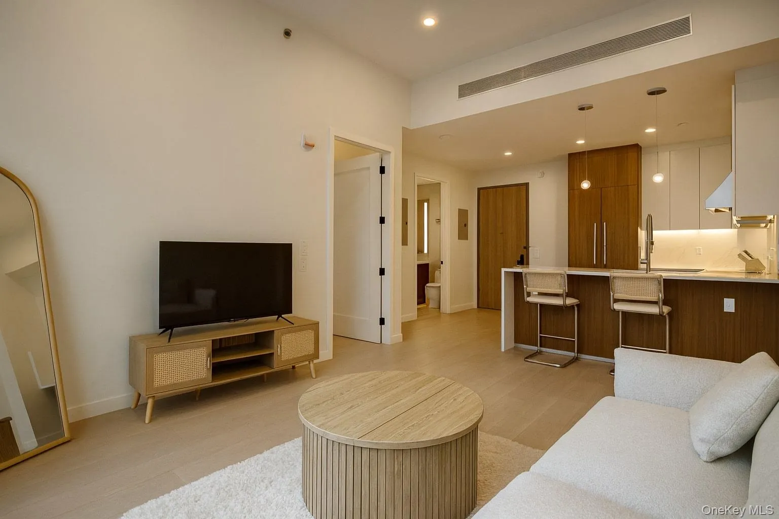 Living area featuring recessed lighting and light wood-style flooring Living area featuring recessed lighting and light wood-style flooring