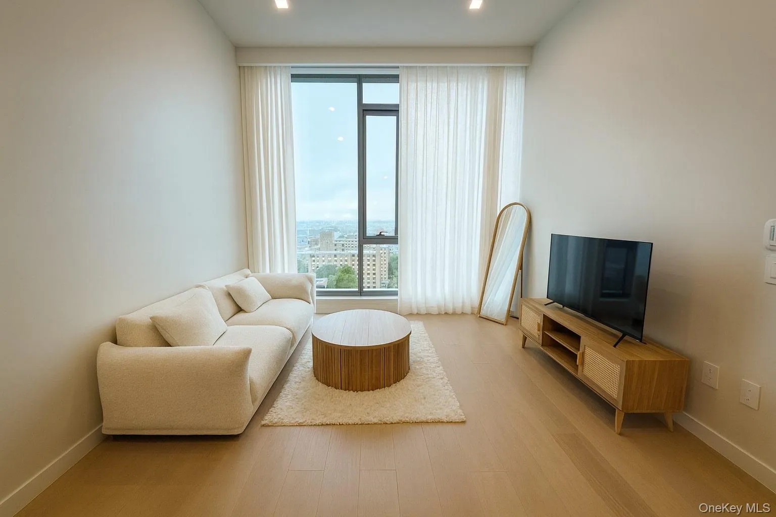 Living room featuring wood finished floors and recessed lighting Living room featuring wood finished floors and recessed lighting
